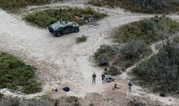 In this Feb. 24, 2015 photo, members of the National Guard patrol along the Rio Grande at the Texas-Mexico border in Rio Grande City, Texas.