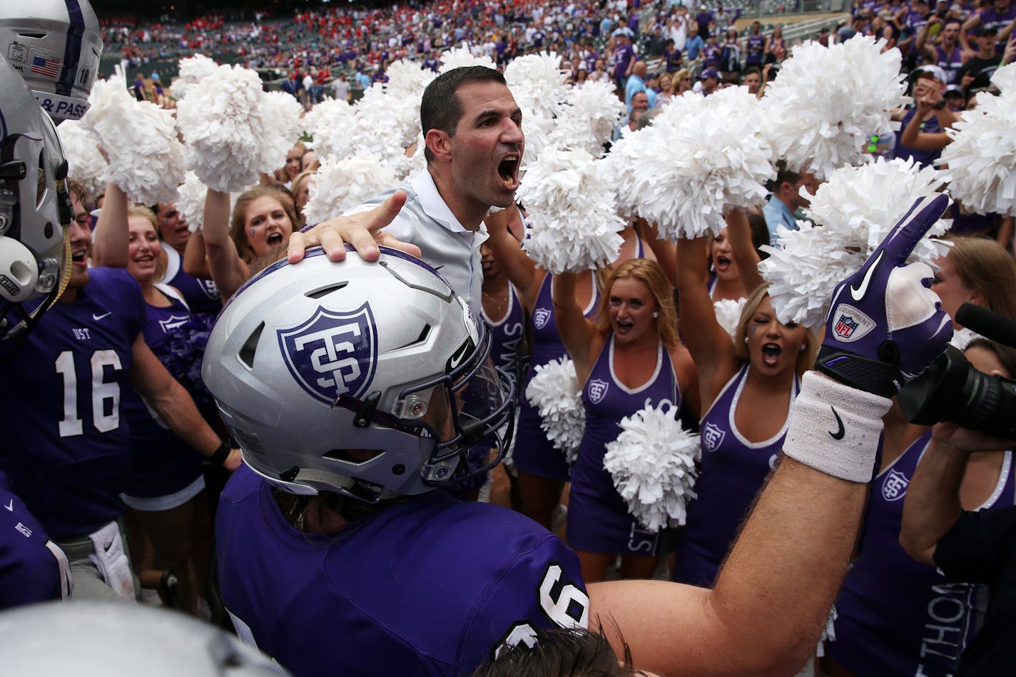 University of St. Thomas coach Glenn Caruso celebrated with his team after a 207 victory over St. John's. at Target Field in Minneapolis.