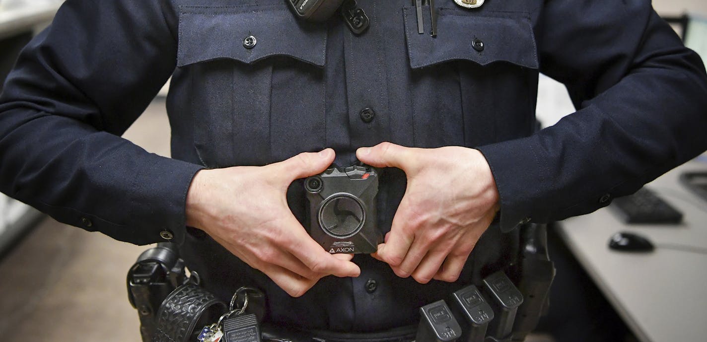 In this Feb. 16, 2017 photo, Maplewood Police Officer Parker Olding attaches his body camera to the magnetic plate worn inside his uniform in Maplewood, Minn. When a Minneapolis police officer shot and killed Justine Damond, who had called in a possible crime in the alley behind her house on July 15, his body camera wasn't running. Criminal-justice experts say the early numbers suggest that officers aren't turning them on often enough, and Minneapolis isn't the only city where that's the case. (