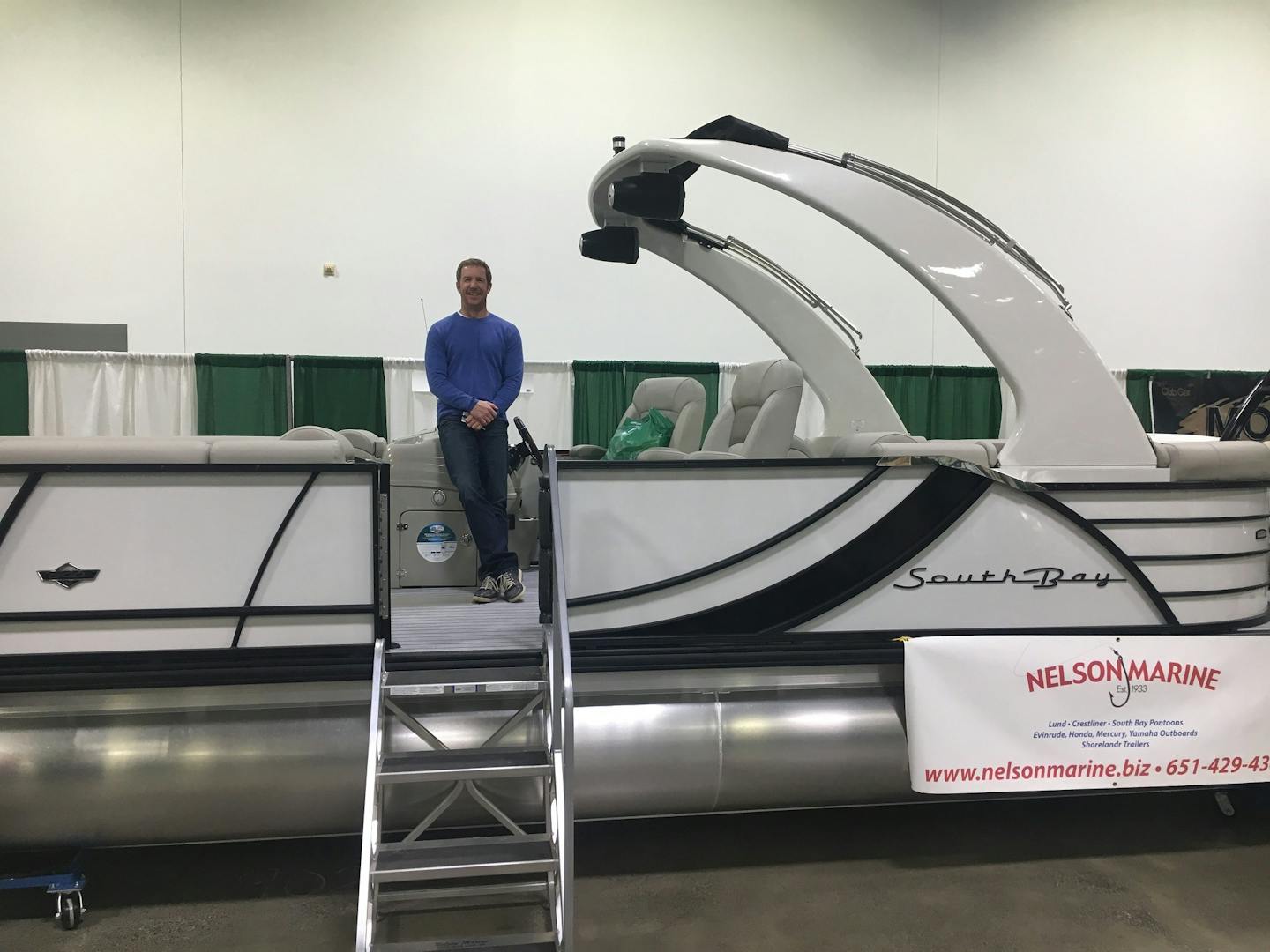 Paul Shadle, of Rosemount, won this pontoon boat and $25,000 by sinking a 120-foot putt at the Venture Minnesota Golf Show.