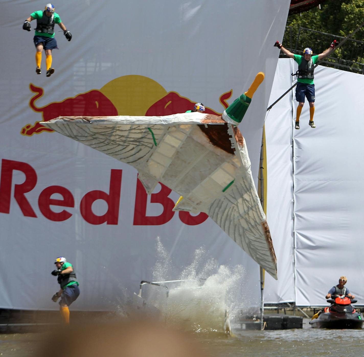 DAVID JOLES ¥ djoles@startribune.com - St. Paul MN - July 24, 2010- Red Bull Flugtag - an amateur flying competition - came to Harriet Island Park in St. Paul, with 37 teams with homemade, man-powered flying machines launched their crafts off a 30-foot platform and attempt to fly or crash in the Mississippi River. In this photo:]Flight crew from Gordon Bombay's Minnesota Miracle Men bail out during the brief flight.