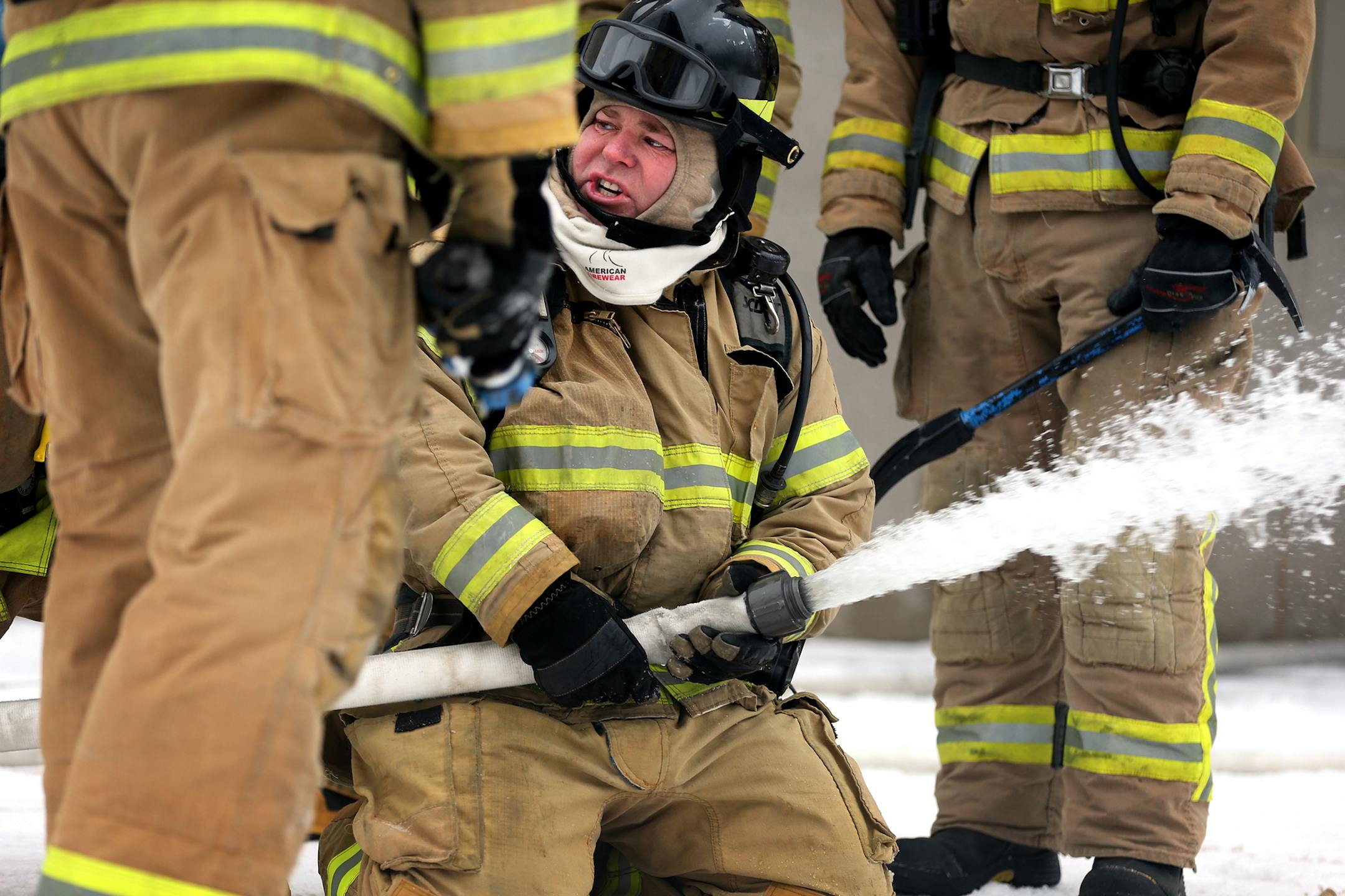 Lino Lakes Police Sergeant Mike Rumpsa trains with the water hose during Fire Fighter I class at the Century College firefighter training facility in Oakdale on Wednesday, December 10, 2014. ] LEILA NAVIDI leila.navidi@startribune.com / BACKGROUND INFORMATION: The city of Lino Lakes has dropped out of the tri-city Centennial Lakes Fire Department and will have it's 26 Lino Lakes Police officers serve as the city's firefighters as well.