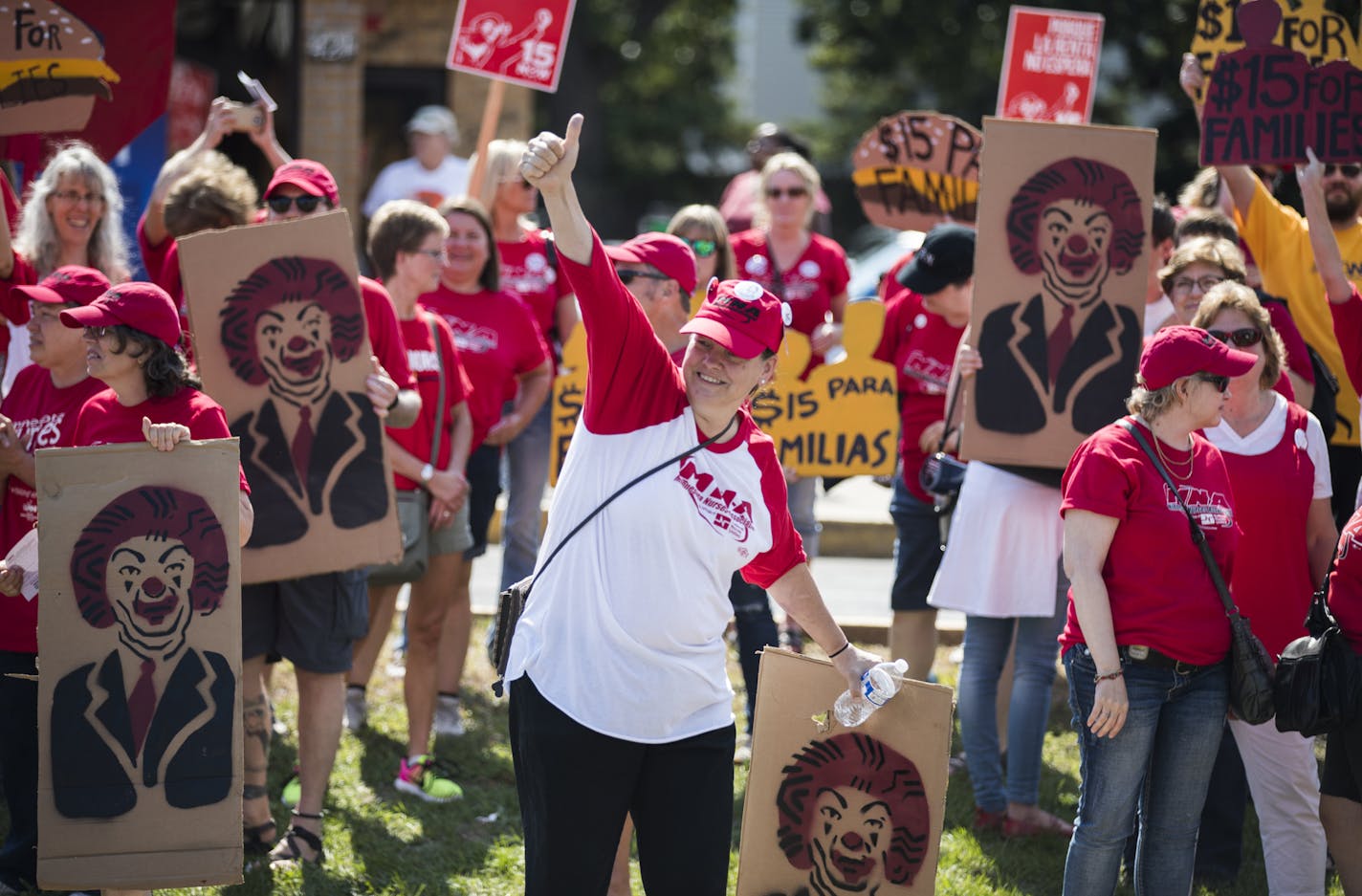 Sonya Worner, center, chanted during a rally Monday on W. Broadway in north Minneapolis for a $15 citywide minimum wage. Activists are urging the City Council to pass an ordinance this year, rather than in 2017.