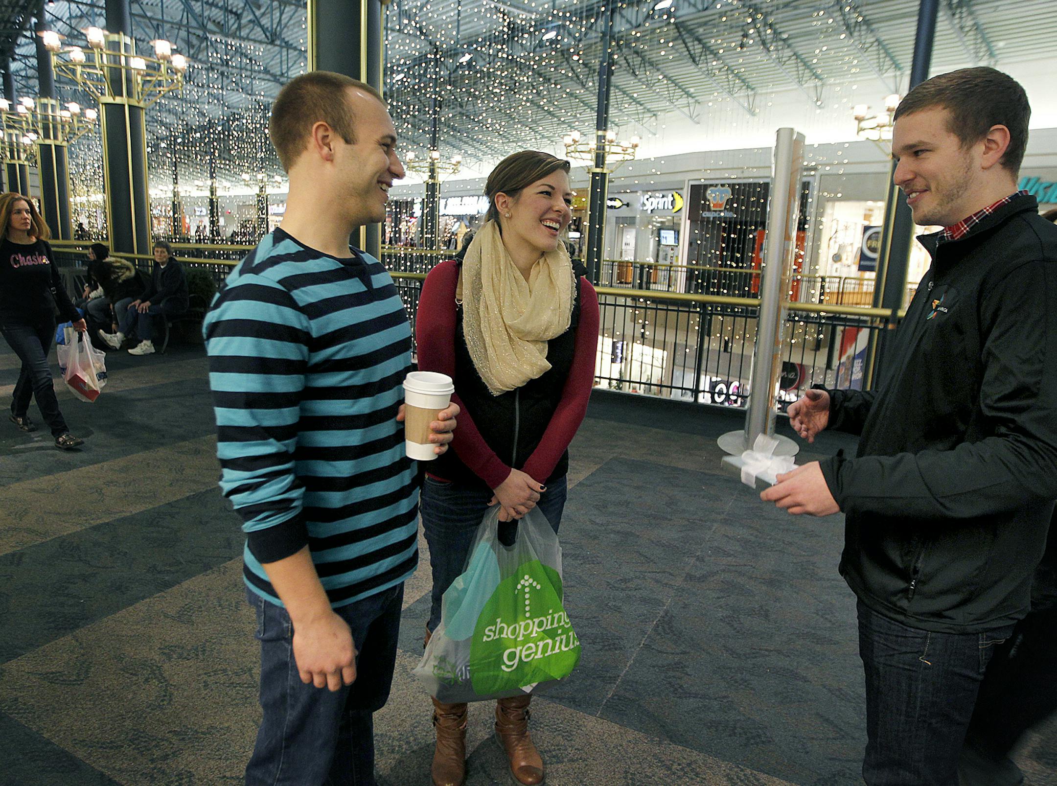David Jungers, the social media strategist at the Mall of America, surprised Nick and Danielle Schmitz of Milwaukee with a $25 gift certificate after responding to a tweet from Jungers after he posted a photo instagram and a message saying he was ready for "Black Friday," shopping at the MOA, Friday, November 29, 2013. (ELIZABETH FLORES/STAR TRIBUNE) ELIZABETH FLORES • eflores@startribune.com