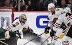 Chicago Blackhawks goalie Corey Crawford (50) eyed the puck as defenseman Jan Rutta (44) defended the crease in the second period. ] AARON LAVINSKY �
