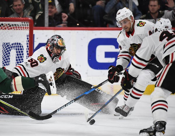 Chicago Blackhawks goalie Corey Crawford (50) eyed the puck as defenseman Jan Rutta (44) defended the crease in the second period. ] AARON LAVINSKY �
