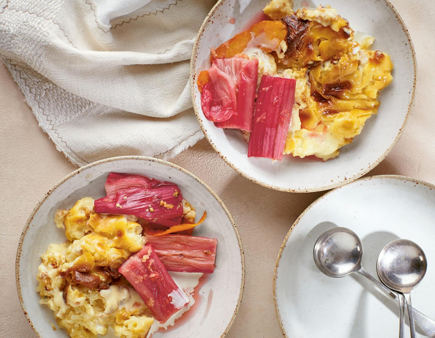 A bowl of baked rice pudding flavored with cardamom and topped with softened rhubarb.