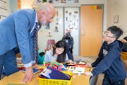 Joe Gothard, the St. Paul Public Schools Superintendent, helps a student, whose parents asked not to be named, with his reading exercise in Rosie Malo