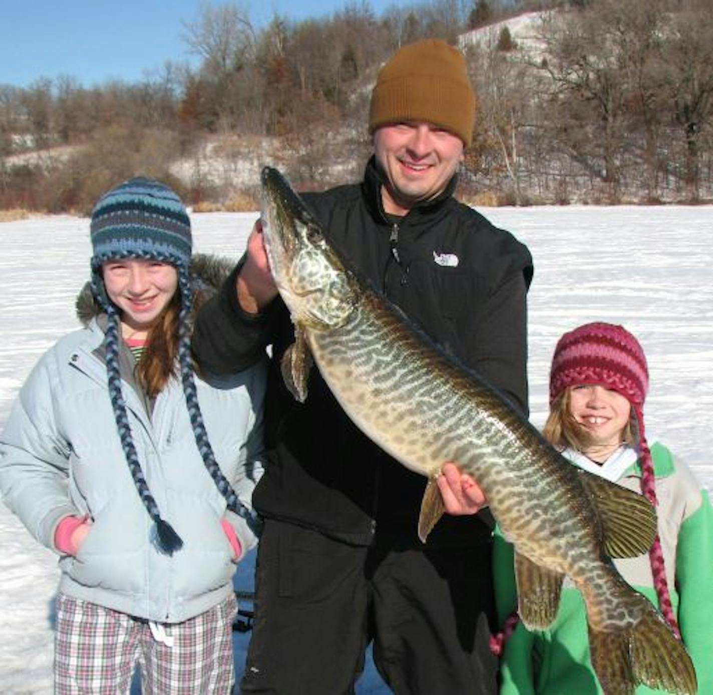 James Friedrichs of Eden Prairie was fishing for crappies with daughters Maddie, 11, and Grace, 8, on Bryant Lake in Eden Prairie recently when this 40-plus inch tiger muskie hit his lure. He fought the fish for 30 minutes. Another angler drilled an extra hole so he'd have enough room to land the fish. "I ended up grabbing it by the tail and pulling it through the hold backwards,'' Friedrichs said. He released the fish.