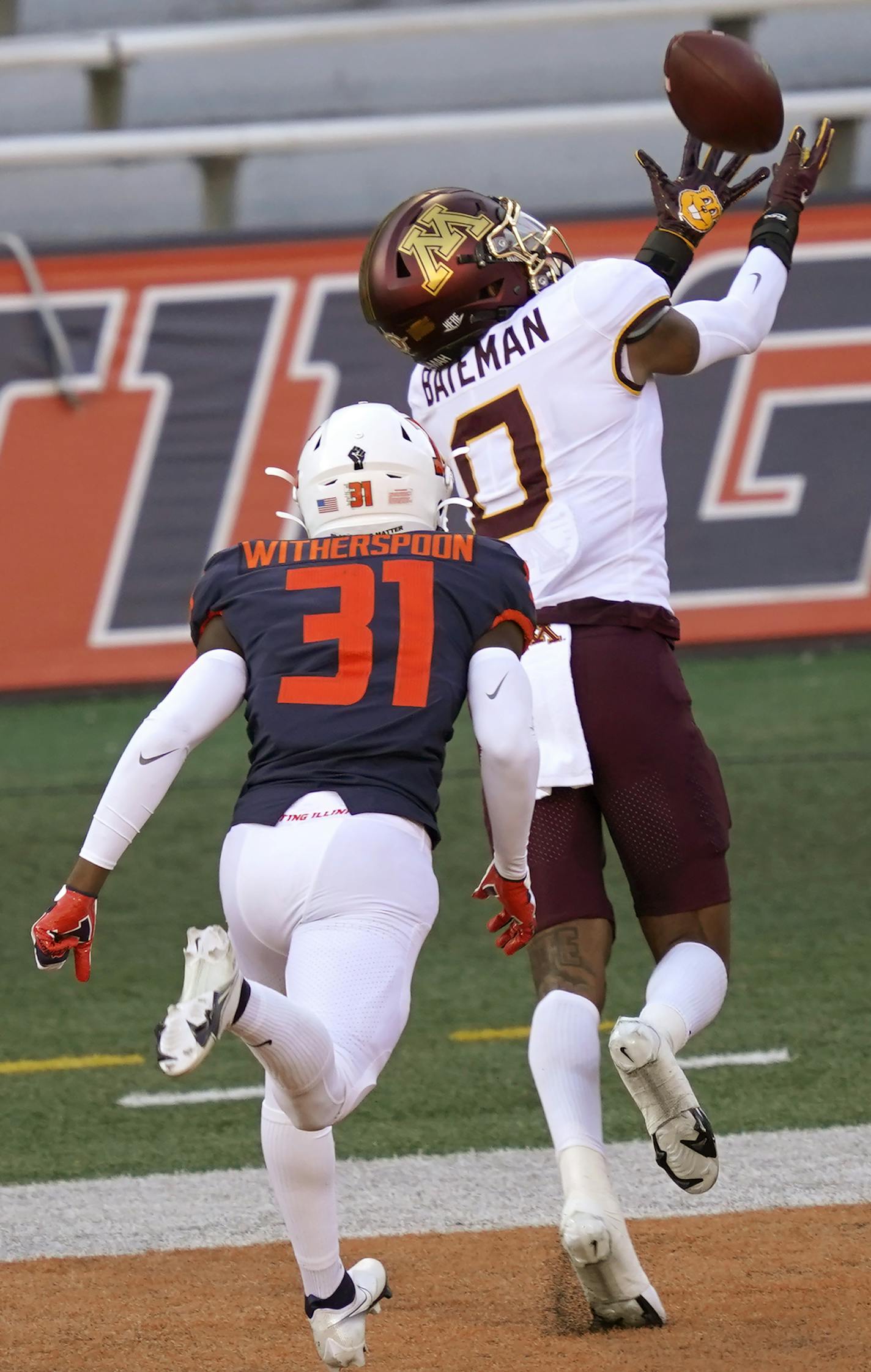 Minnesota wide receiver Rashod Bateman (0) catches a touchdown pass from quarterback Tanner Morgan, as Illinois defensive back Devon Witherspoon defends during the first half of an NCAA college football game Saturday, Nov. 7, 2020, in Champaign , Ill. (AP Photo/Charles Rex Arbogast)