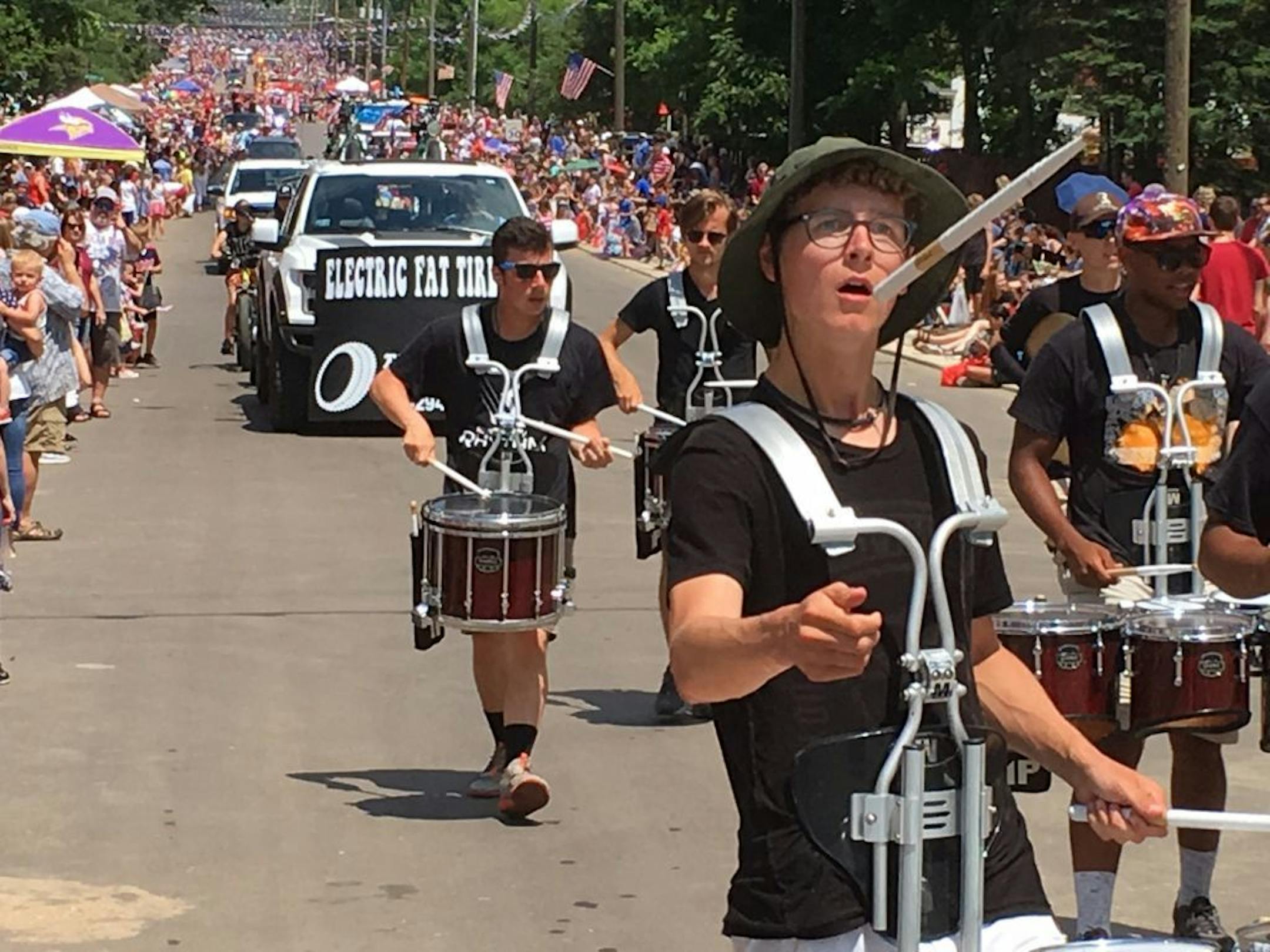A drummer shows off his juggling skills on Afton's rebuilt Main Street during last week's Fourth of July parade. The road work, which includes new sidewalks and curbs, isn't completed, but Mayor Richard Bend said it was "unthinkable" to miss having the popular Washington County parade.