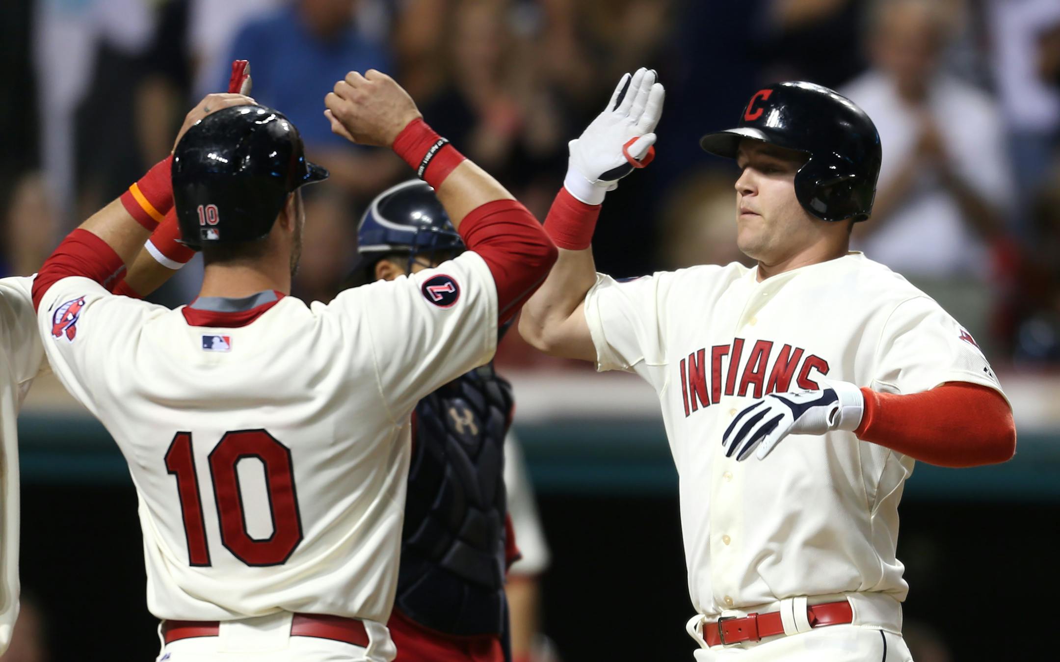 Cleveland Indians' Jerry Sands, right, gets congatulations from Yan Gomes after hitting a grand slam off Minnesota Twins relief pitcher Blaine Boyer during the fifth inning of a baseball game, Saturday, Aug. 8, 2015, in Cleveland. (AP Photo/Ron Schwane)