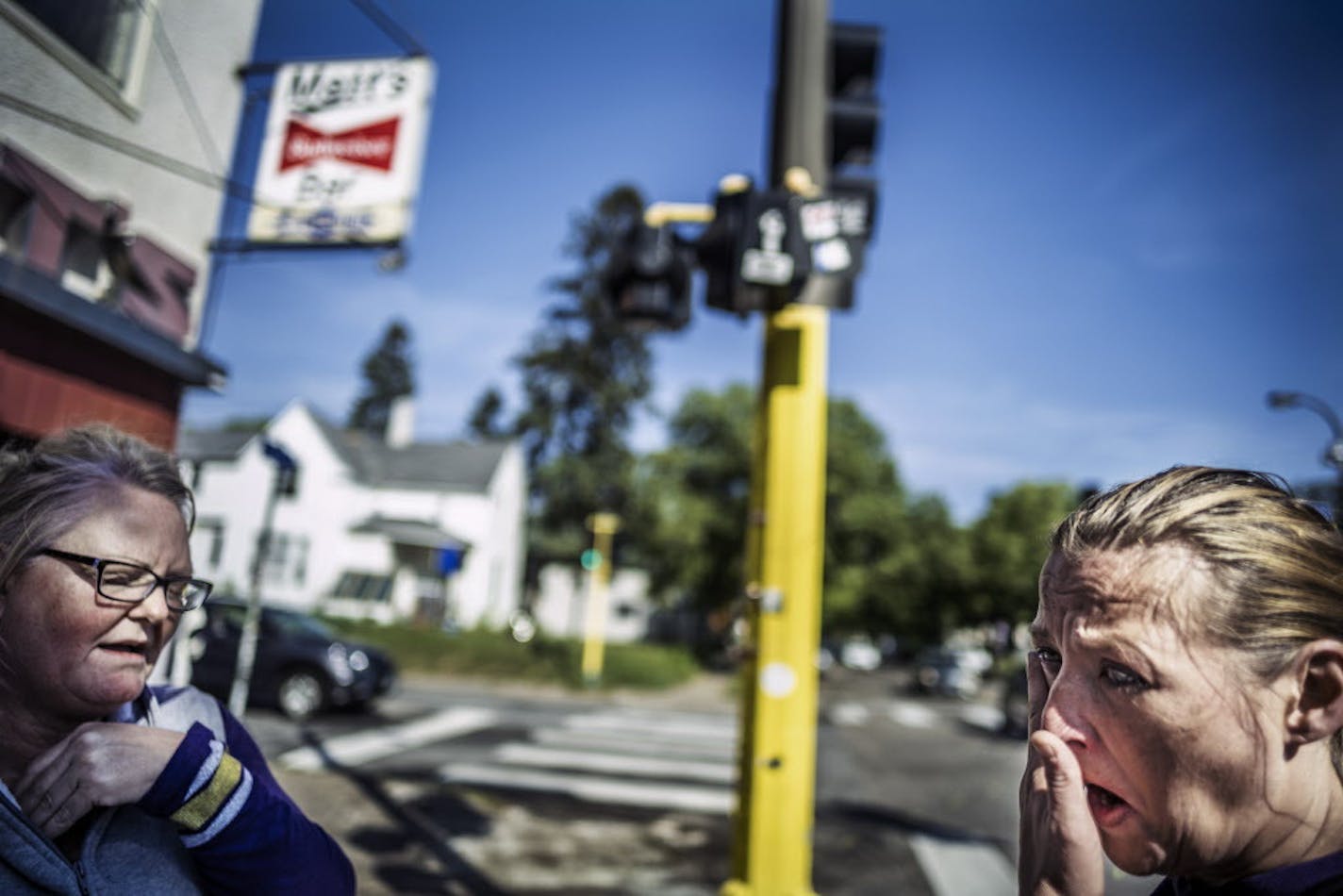 AnnDee Gunderson,left, and Natasha Gunderson became emotional recalling their cousin Kimberly Gunderson who died in a vehicular crash around one AM Sunday in front of Matt's Bar. They left a bouquet of roses for her cousin.] Richard Tsong-Taatarii@startribune.com