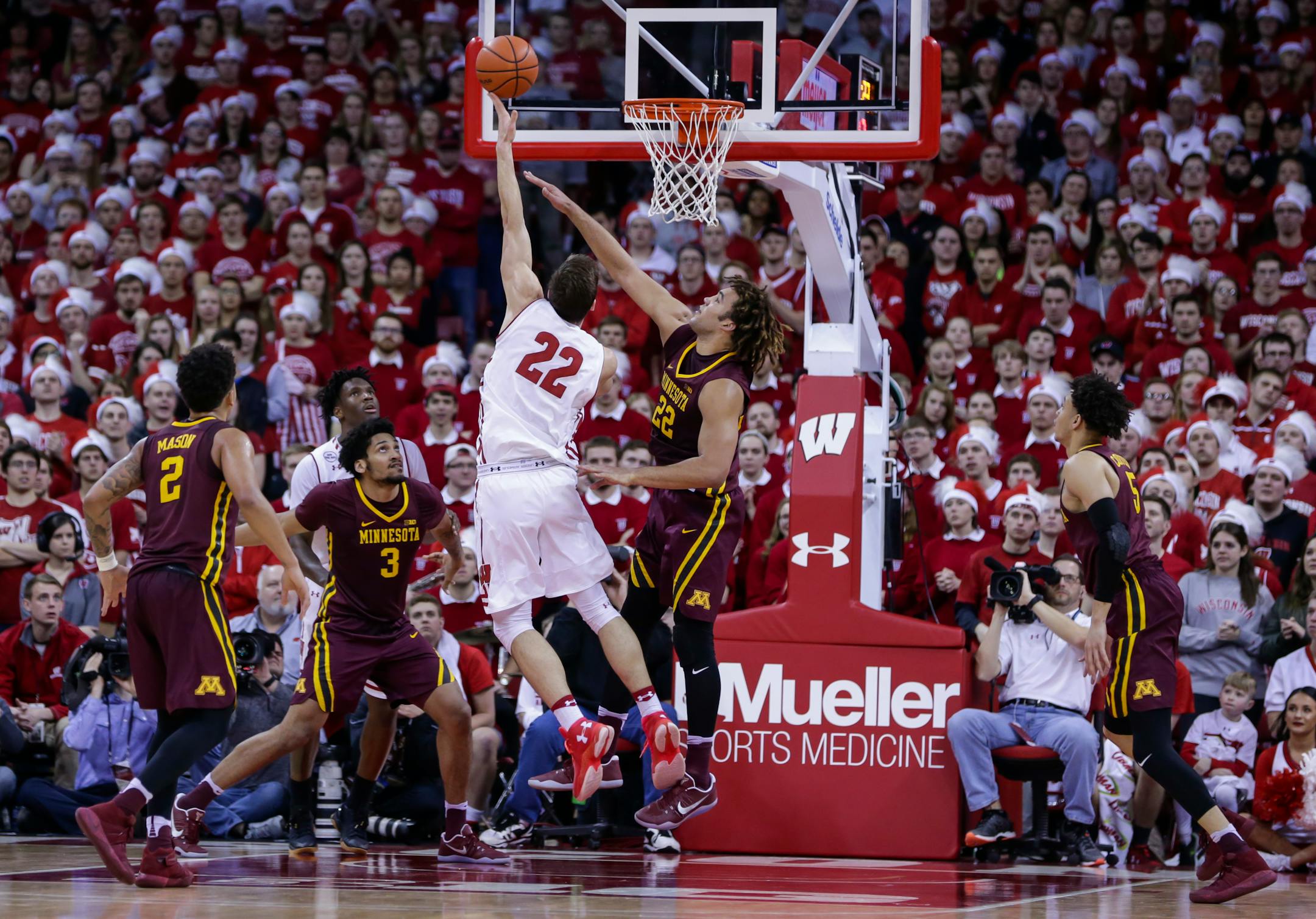 Wisconsin's Ethan Happ (22) shots against the Gophers' Reggie Lynch during the Badgers' 66-49 victory Sunday in Madison, Wis.