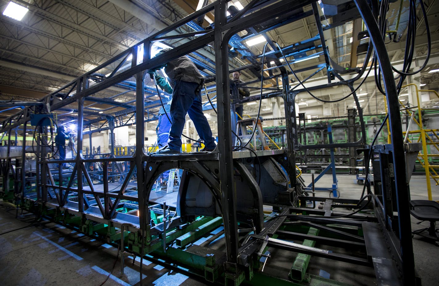 Welders worked on a new bus frame at New Flyer on Monday, November 30, 2015, in St. Cloud, Minn. ] RENEE JONES SCHNEIDER &#x2022; reneejones@startribune.com