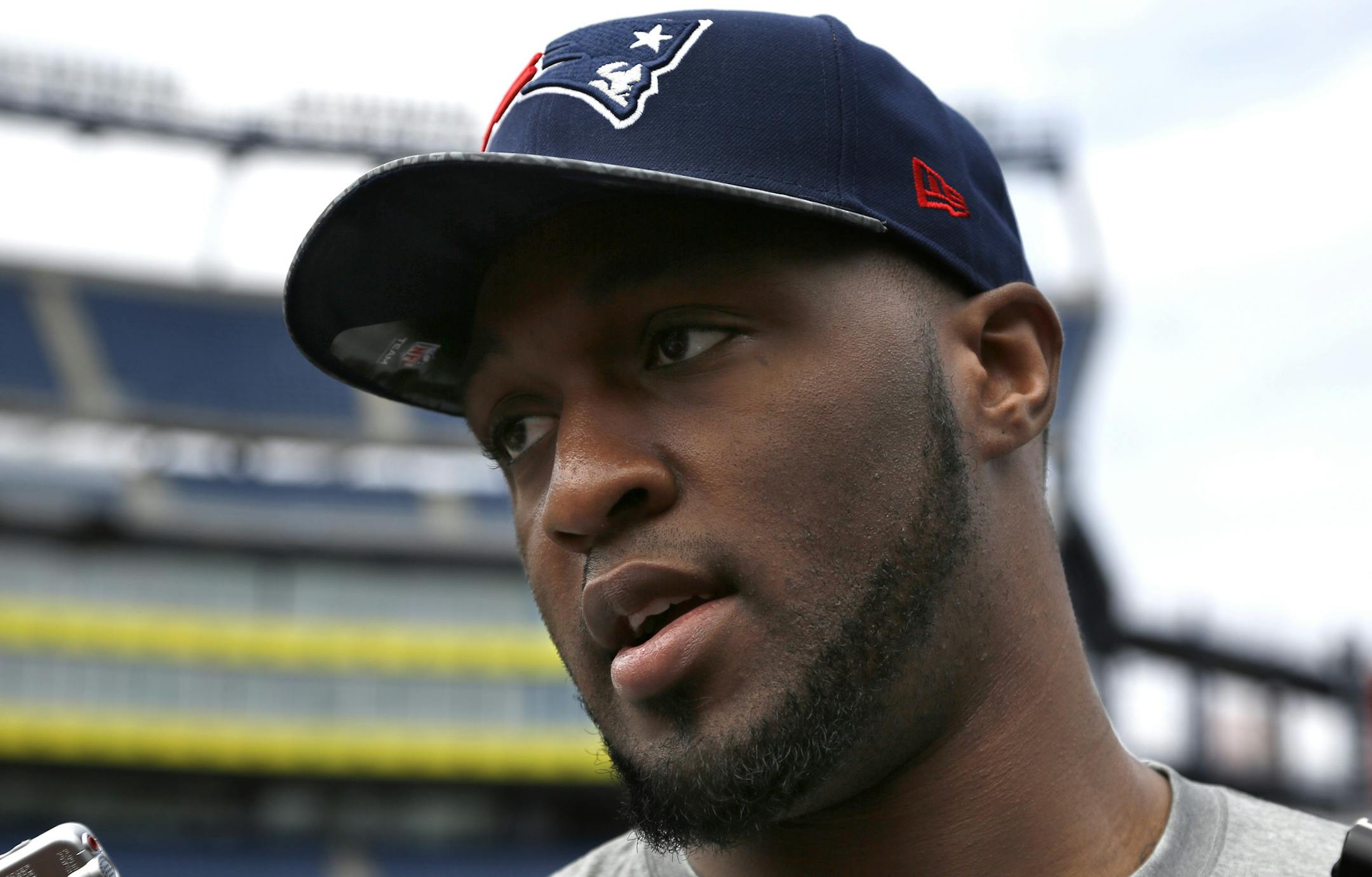 New England Patriots rookie NFL football defensive lineman Zach Moore speaks with members of the media on the field at Gillette Stadium, in Foxborough, Mass., Tuesday, May 13, 2014. (AP Photo/Steven Senne) ORG XMIT: MASR105