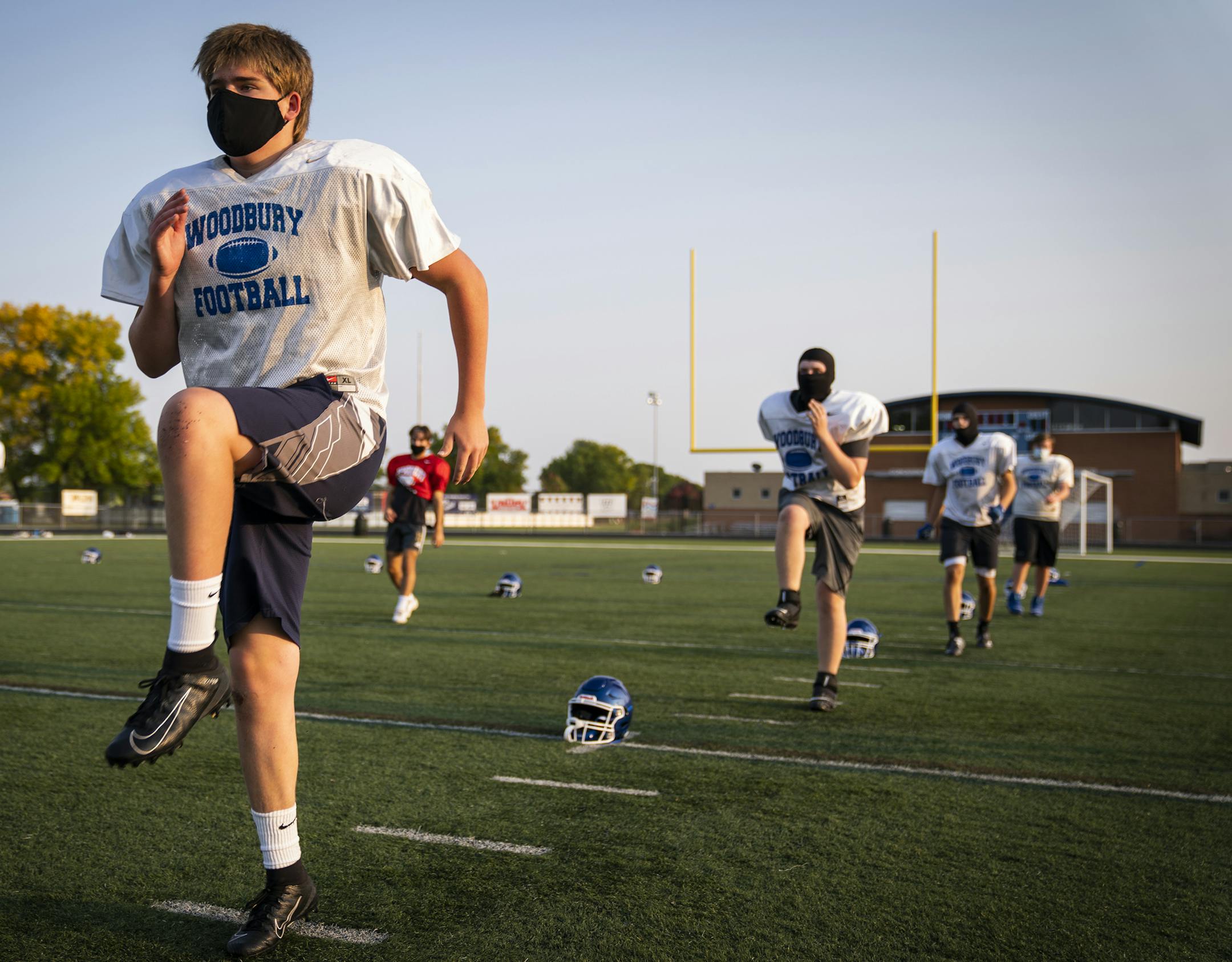 Offensive lineman Garrett Prestholdt warmed up during Woodbury High School football practice. ] LEILA NAVIDI • leila.navidi@startribune.com BACKGROUND INFORMATION: Woodbury High School football team practiced at their field in Woodbury on Monday, September 21, 2020. The Minnesota State High School League voted to allow football and volleyball teams to play for the fall season.