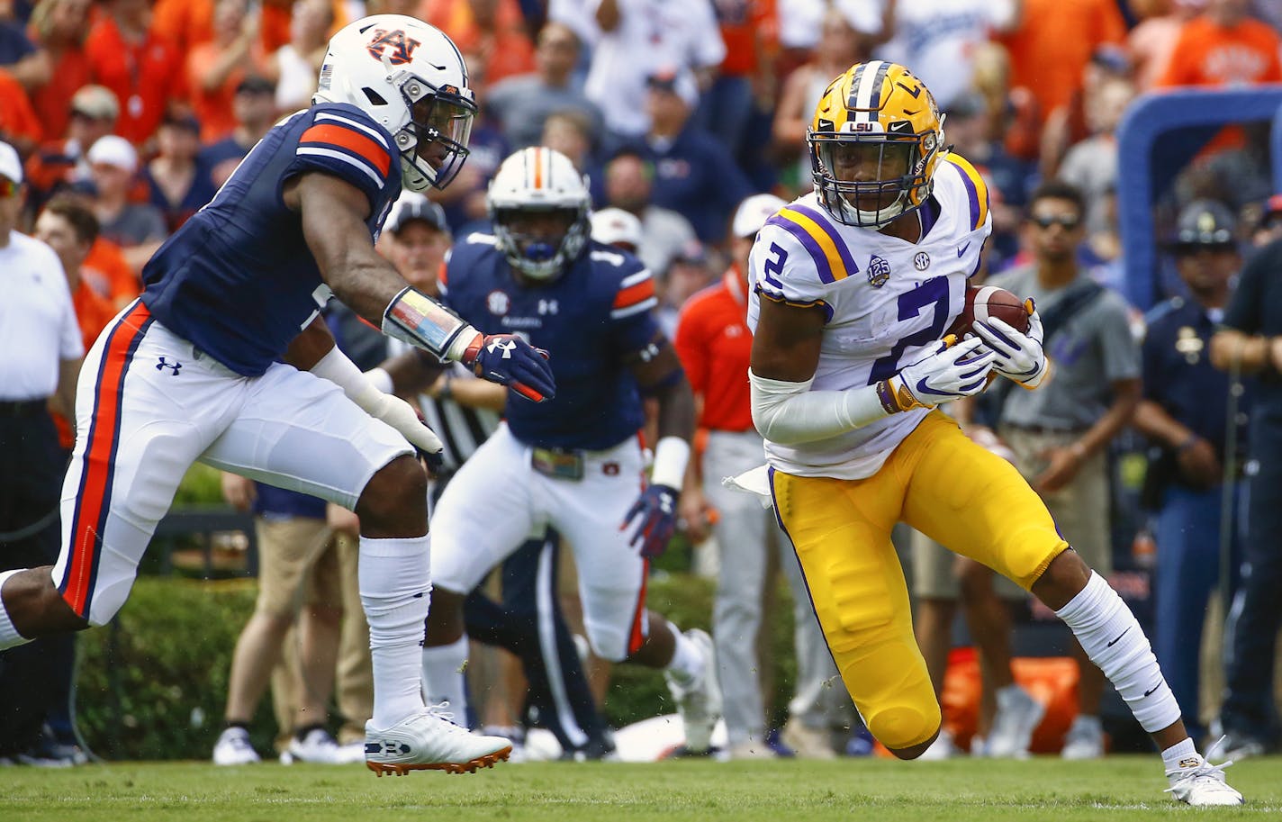 LSU wide receiver Justin Jefferson (2) catches a pass and tries to get around Auburn defensive back Noah Igbinoghene (4) as he carries the ball during the first half of an NCAA college football game, Saturday, Sept. 15, 2018, in Auburn, Ala. (AP Photo/Butch Dill) ORG XMIT: ALBD104