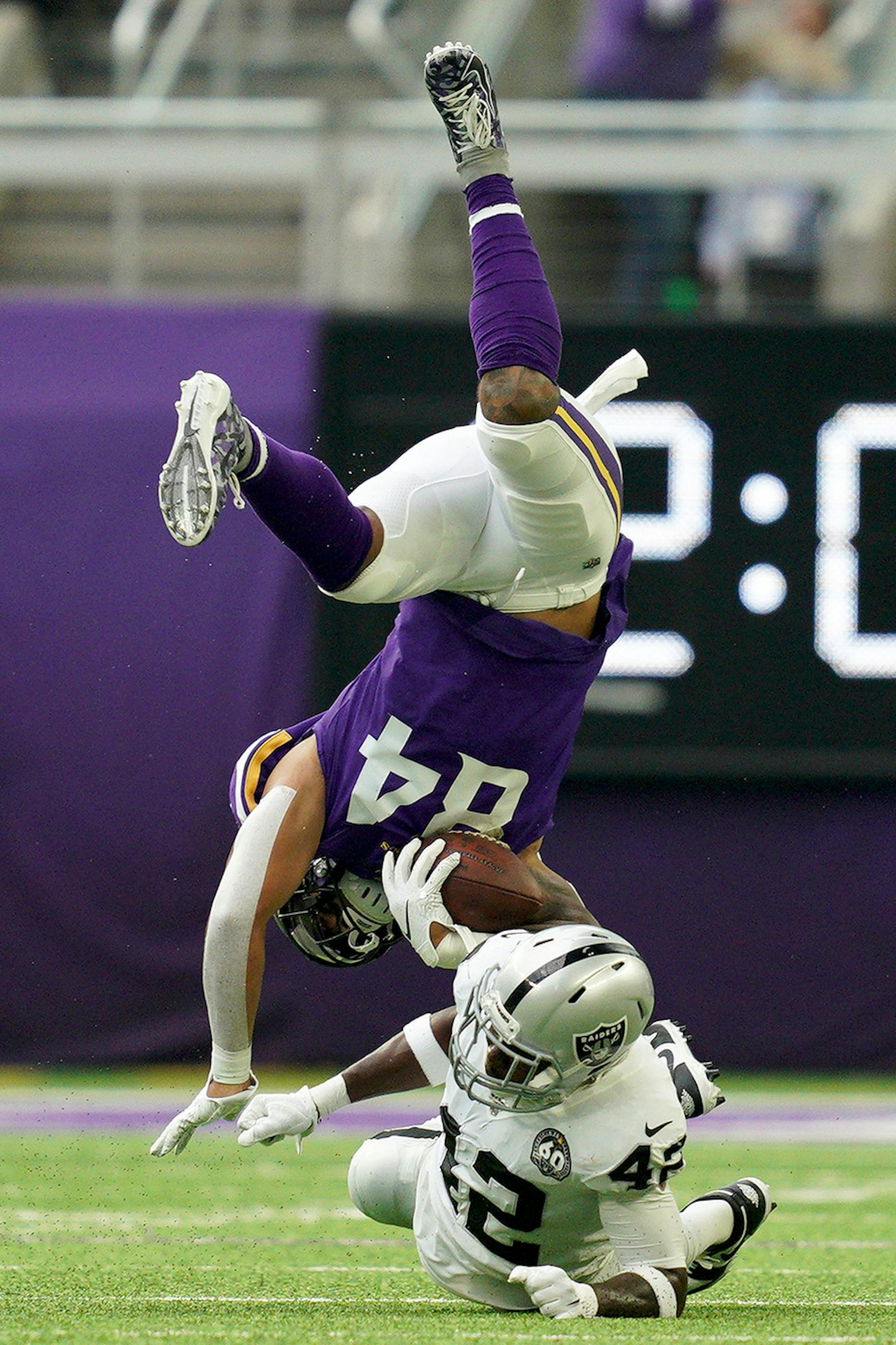 Minnesota Vikings tight end Irv Smith (84) got flipped by Oakland Raiders free safety Karl Joseph (42) as he ran with the ball in the first quarter.