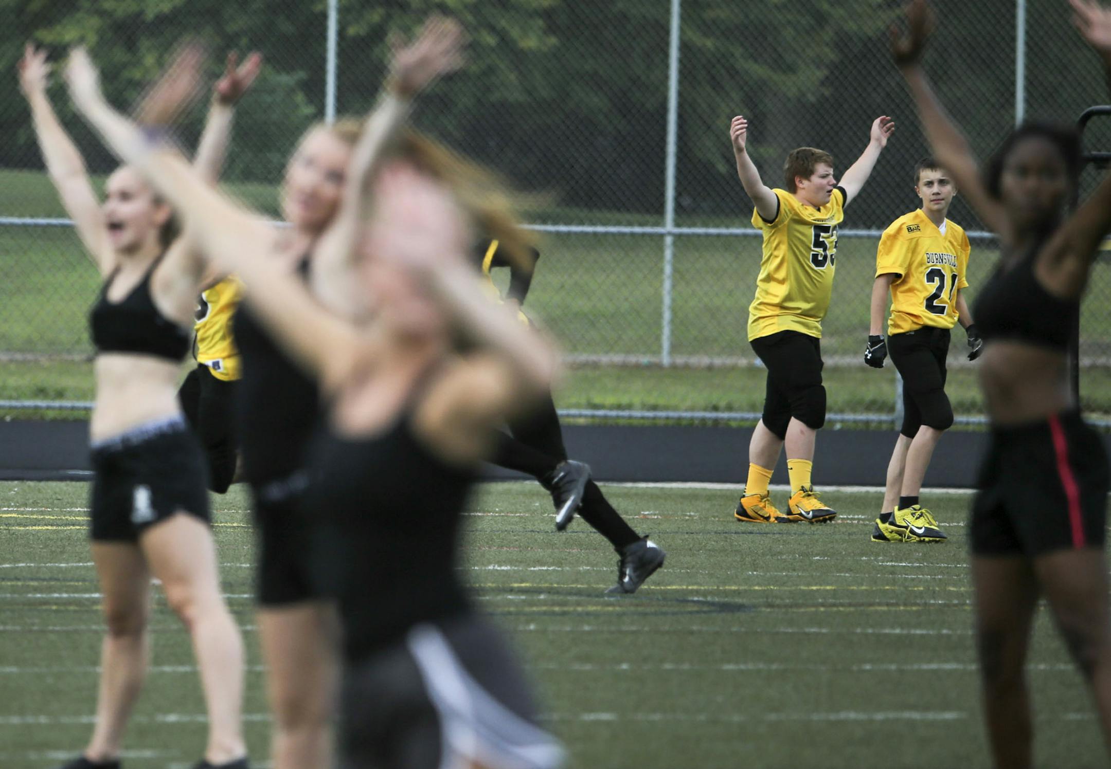 As members of the Blaze Blazettes dance team warm up on the field, youth football players begin to arrive for the Burnsville Football's fourth annual "Kick Off Bash" Friday, Aug. 22, 2014, at Burnsville High School in Burnsville, MN. (DAVID JOLES/STARTRIBUNE) djoles@startribune Burnsville Football's fourth annual "Kick Off Bash" will be held on Friday, Aug. 22 from 5-8 p.m. in Bob Pates Stadium at Burnsville High School.