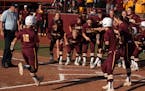 Gophers shortstop Allie Arneson (16) was mobbed by her teammates as the plate after hitting a home run in the fifth inning to put the Gophers on the b