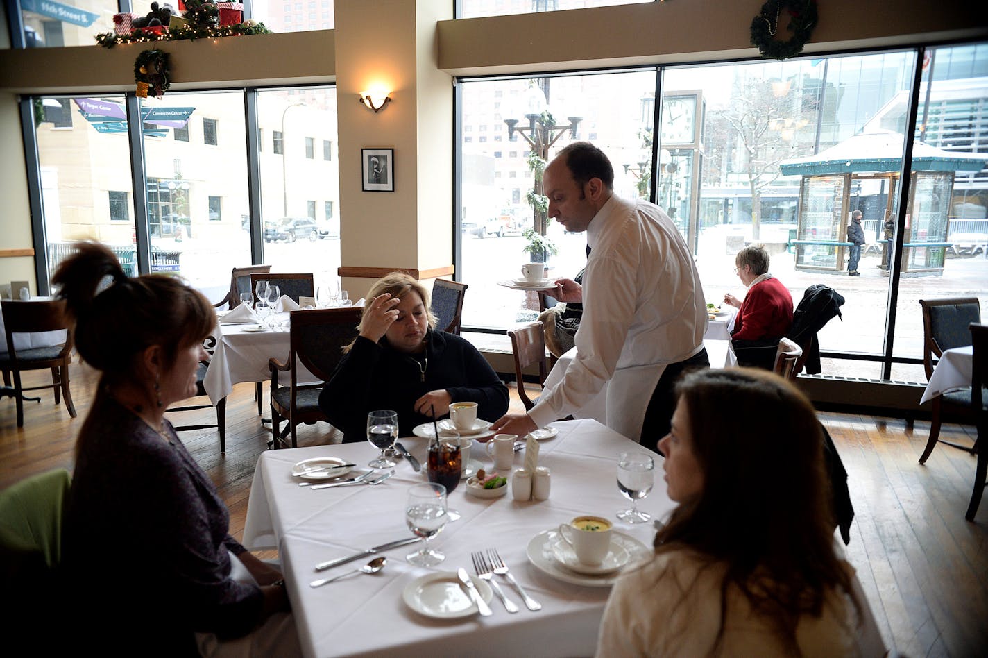 Annie Zomermaand (left), Monica Brown (center) and Kristel Corson are served soup during a recent outing to Vincent's lunch menu. ] (SPECIAL TO THE STAR TRIBUNE/BRE McGEE) **Annie Zomermaan (purple shirt, left), Monica Brown (black shirt, center), Kristel Corson (white shirt, right)