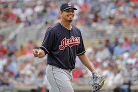 Cleveland Indians starting pitcher Carlos Carrasco (59) smiles as he leaves the field with a lead over the Minnesota Twins in the eighth inning of a b
