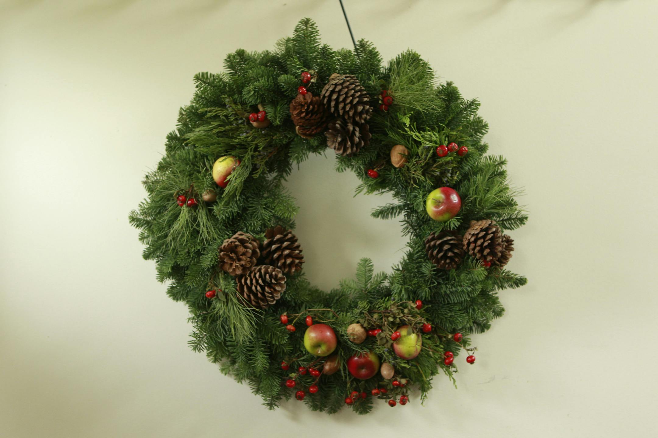 A holiday wreath crafted for use through the winter .