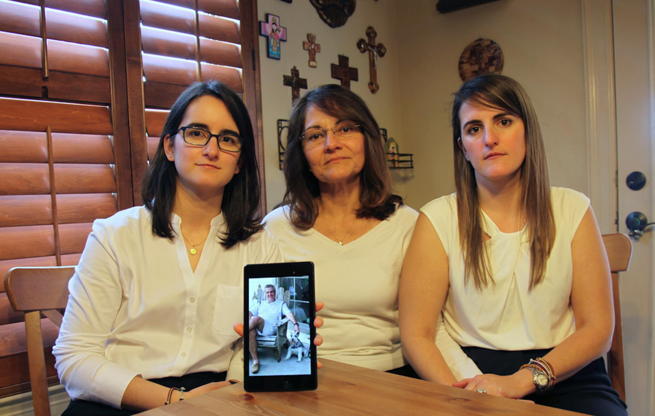 Dennysse Vadell in February 2019 with her daughters Veronica, right, and Cristina holding a digital photograph of father and husband Tomeu who is jailed in Venezuela with five other executives from Houston-based Citgo, in Katy, Texas.