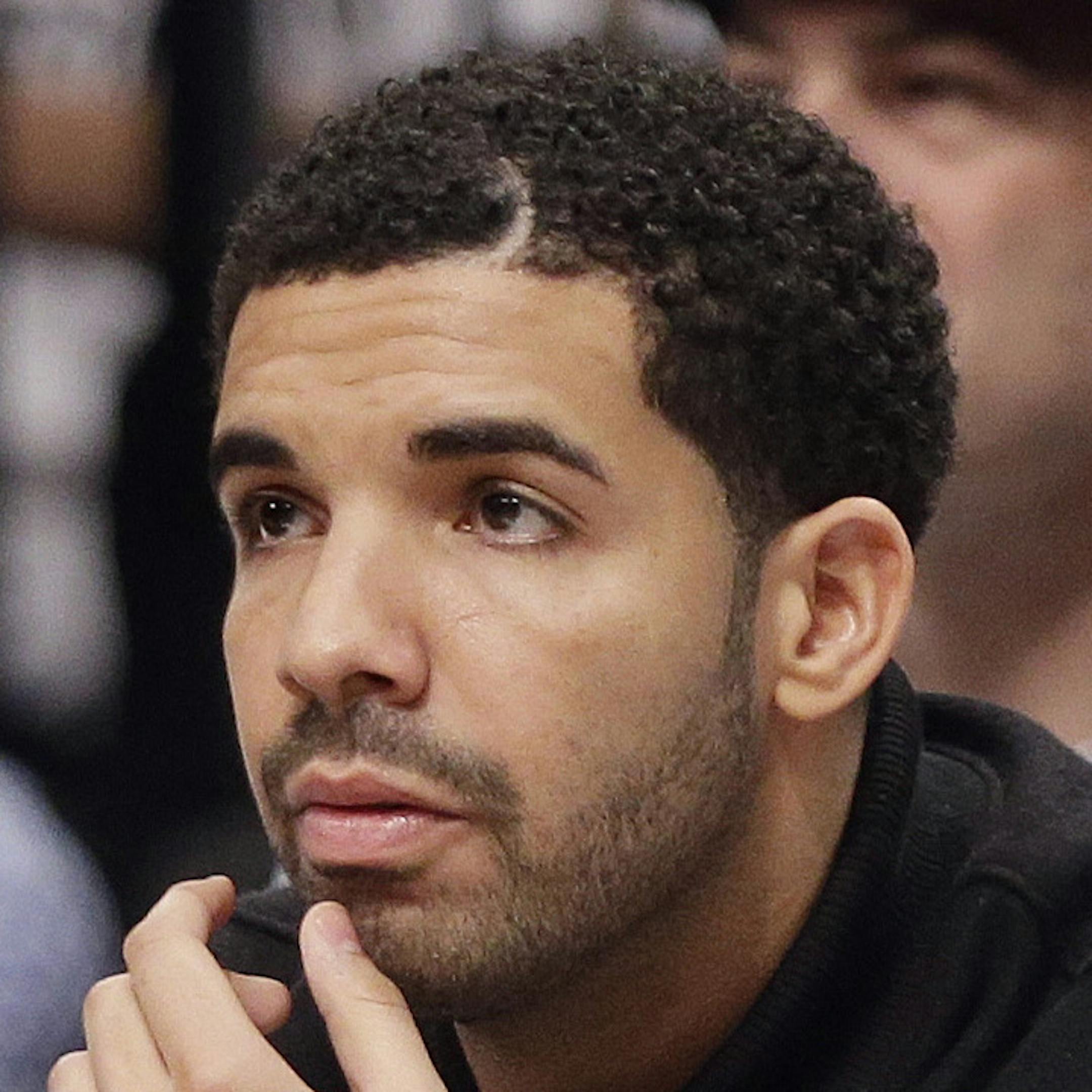 Rap artist Drake watches during the first half of Game 6 of the opening-round NBA basketball playoff series between the Brooklyn Nets and the Toronto Raptors, Friday, May 2, 2014, in New York. (AP Photo/Frank Franklin II)