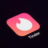 FILE - This Tuesday, July 28, 2020, file photo shows the icon for the Tinder dating app on a device in New York. The use of dating apps in the last 18 months of the pandemic has surged around the globe. Tinder reported 2020 as its busiest year. (AP Photo/Patrick Sison, File)
