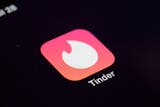 FILE - This Tuesday, July 28, 2020, file photo shows the icon for the Tinder dating app on a device in New York. The use of dating apps in the last 18 months of the pandemic has surged around the globe. Tinder reported 2020 as its busiest year. (AP Photo/Patrick Sison, File)