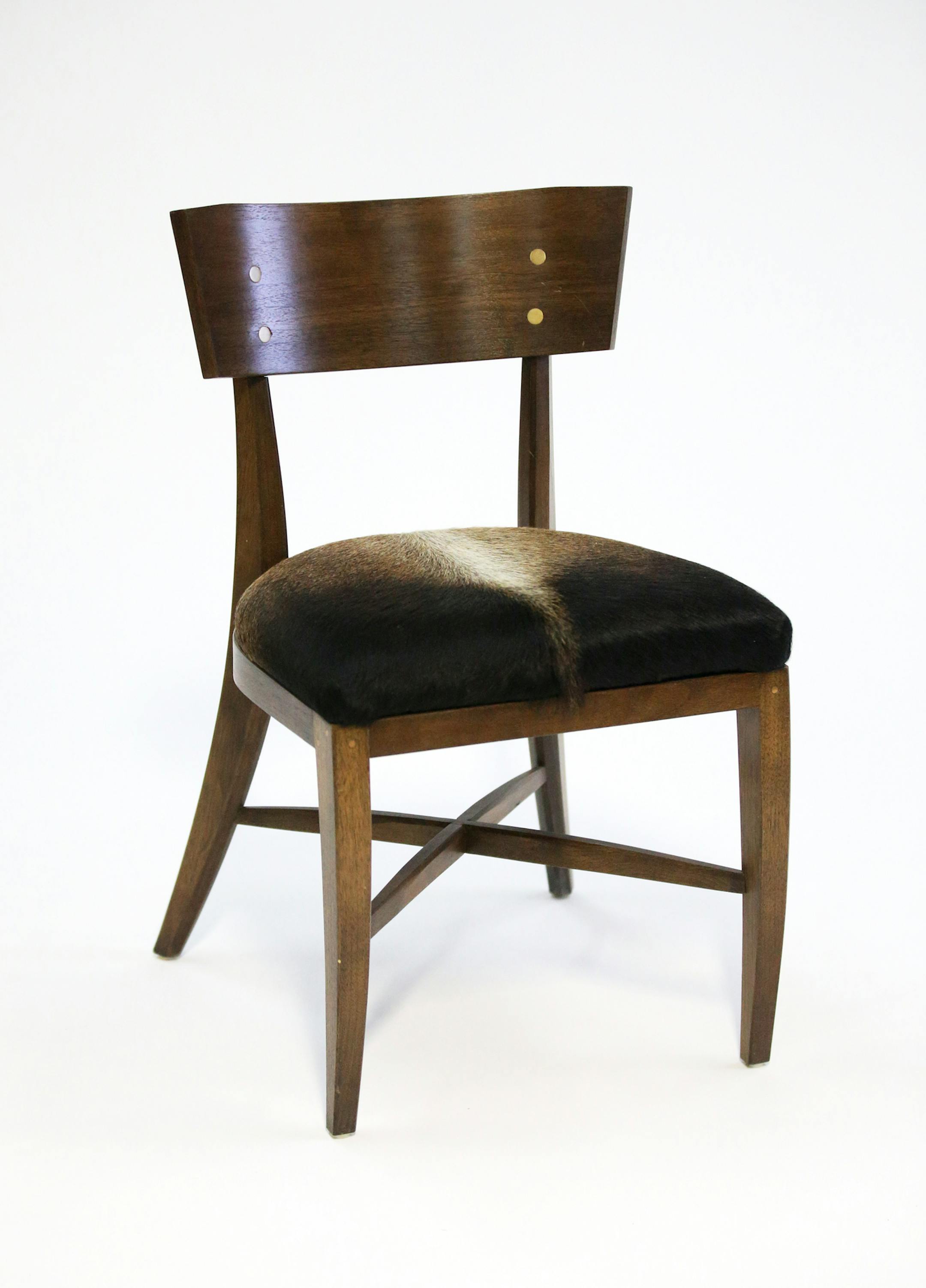 The Raleigh, a custom walnut chair with cowhide seat and brass accents.