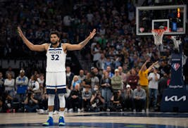 Minnesota Timberwolves center Karl-Anthony Towns (32) signaled the crowd to quiet down for a teammate to shoot free throws late in the fourth quarter 