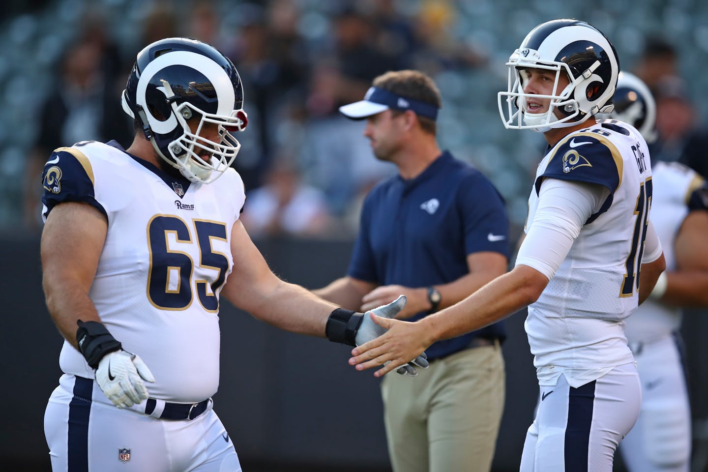 Former Vikings center John Sullivan (65) helped quarterback Jared Goff, right, and the Rams be the second-highest scoring offense in the NFL this season (32.9 points per game).