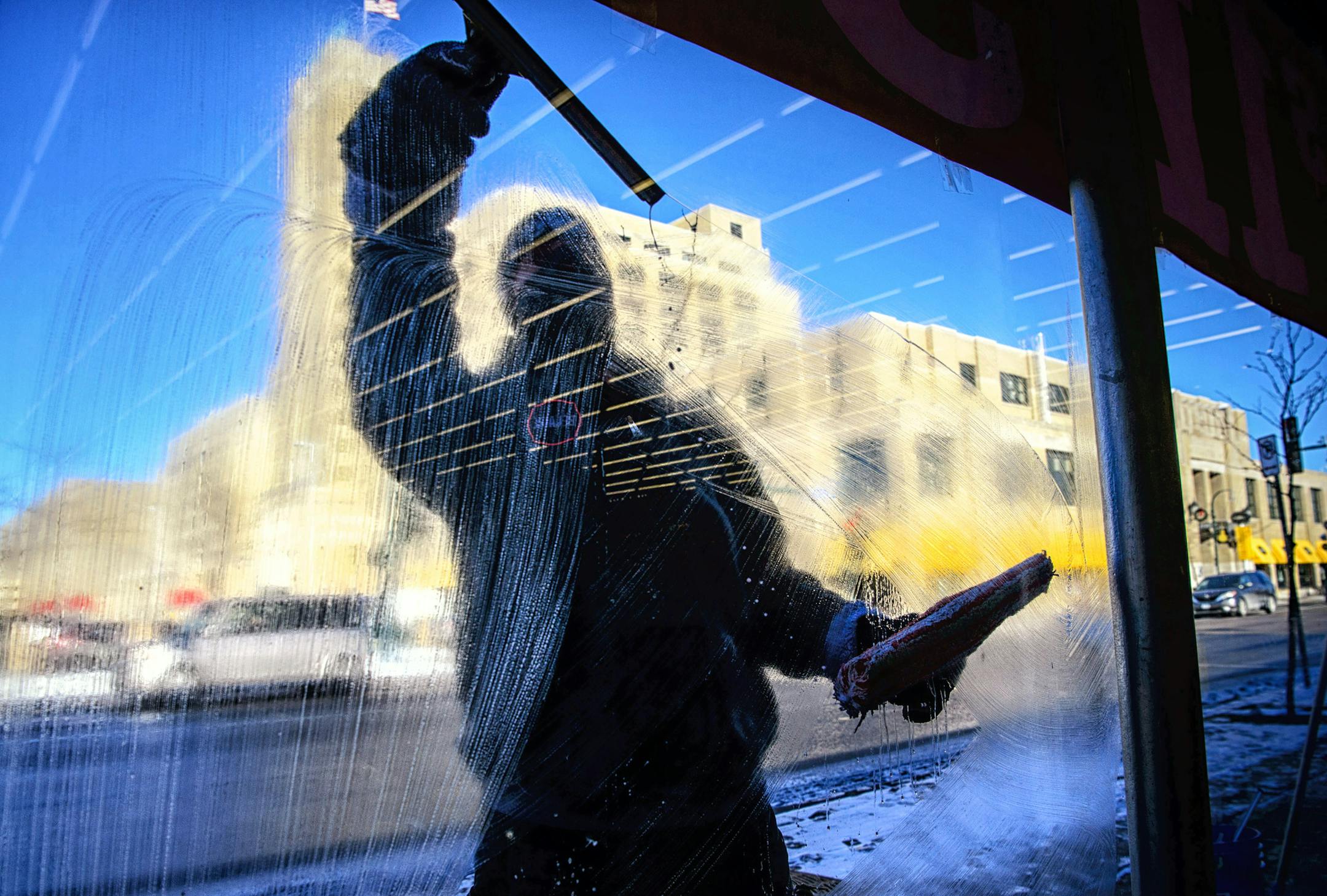 "Layers and layers and layers and layers" Daniel Perfetti said when asked how he stays warm while professionally washing windows all day in single digit temperatures. "If its a Tuesday, these customers want clean windows, they don't care what the temperature is." Even though he uses a mixture of 100 percent methanol and Dawn soap, he figures he only has seconds at zero degrees before the wondows start to freeze. "I actually feel warm when I'm on the sunny side of the street, the shady side, that
