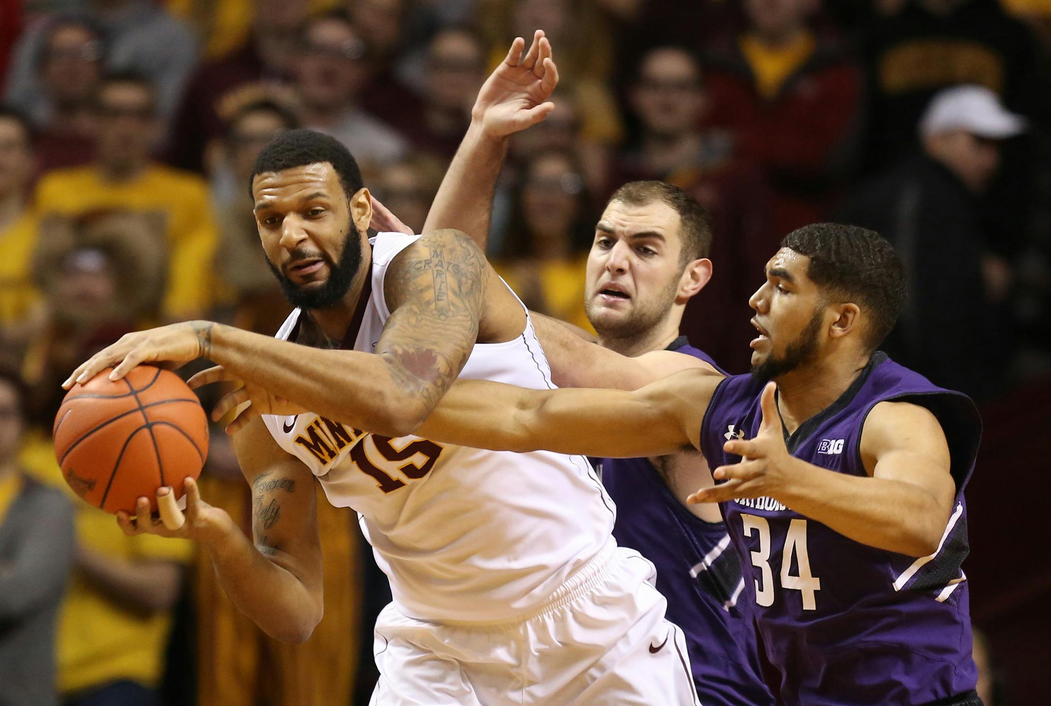 Maurice Walker pulled down an offensive rebound being double teamed by Northwestern during the first half.