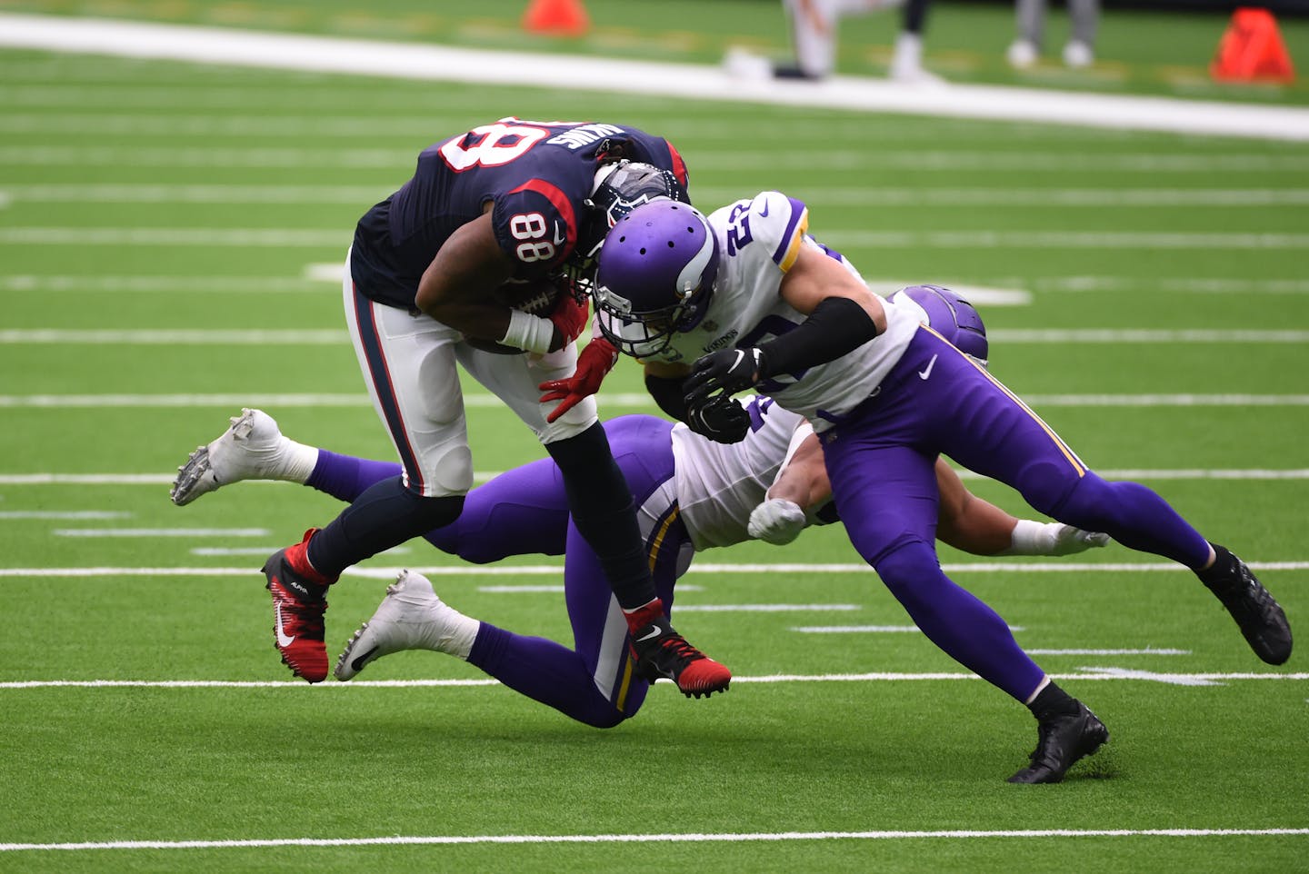 Texans tight end Jordan Akins is hit by Vikings safety Harrison Smith, right, after catching a pass during the first half