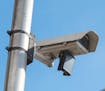 A surveillance camera system attached to a light pole. The Oakland, Calif., City Council voted to prohibit the use of facial recognition technology by