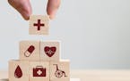 iStock
Hand arranging wood block stacking with icon healthcare medical, Insurance for your health concept
