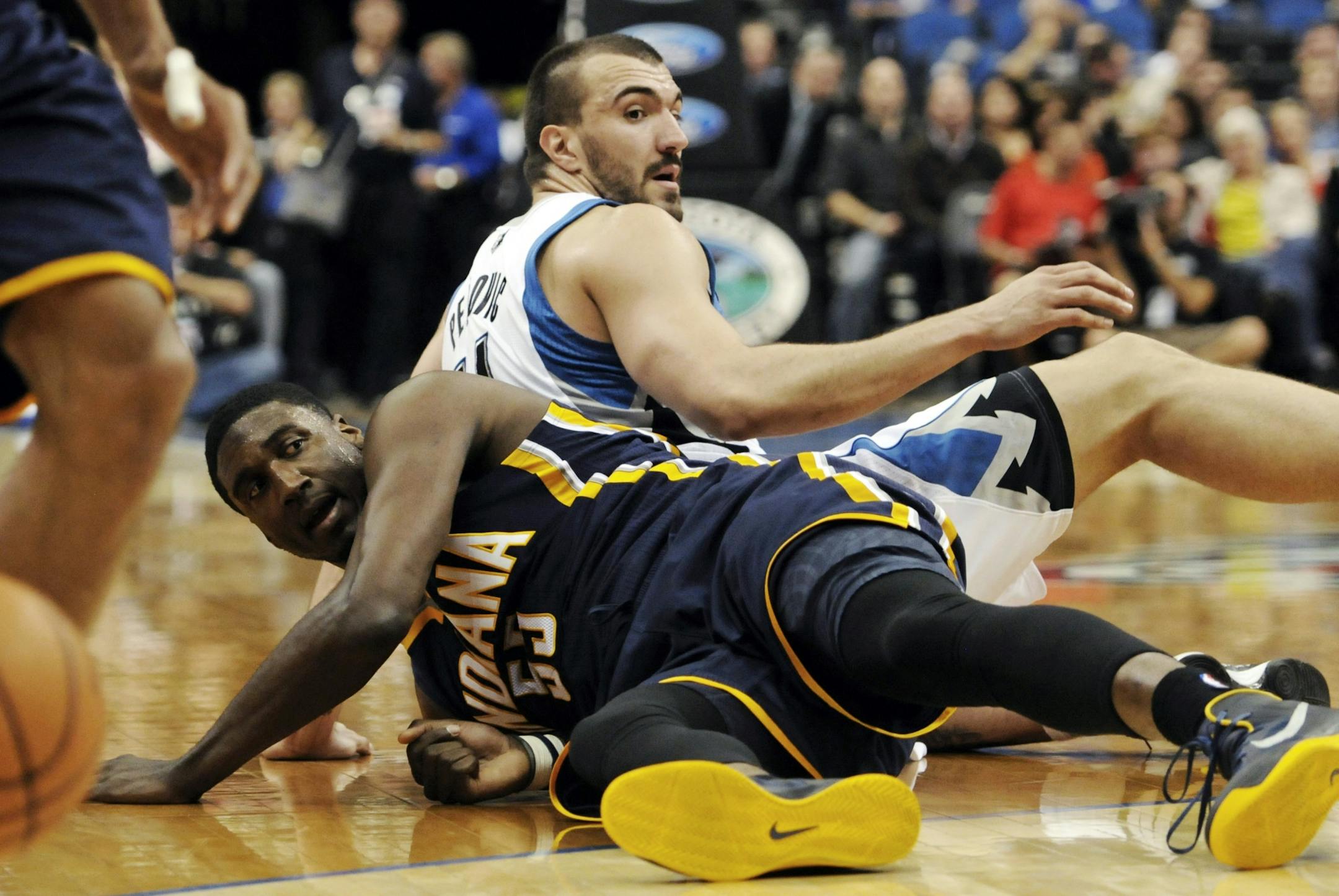 Indiana Pacers' Roy Hibbert, left, and Minnesota Timberwolves' Nikola Pekovic, of Montenegro, watch the loose ball after colliding in the first half of an NBA basketball game, Friday, Nov. 9, 2012, in Minneapolis.
