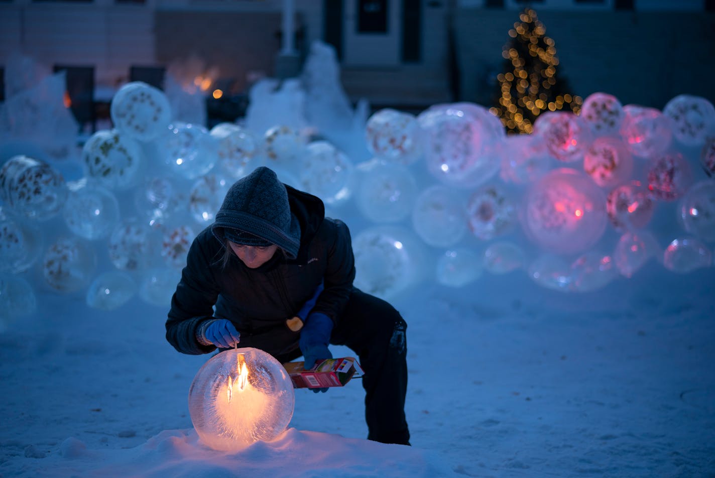 Jennifer Shea Hedberg lit one of her ice luminaries before friends arrived for an outdoor chili dinner on her front patio. ] JEFF WHEELER • jeff.wheeler@startribune.com