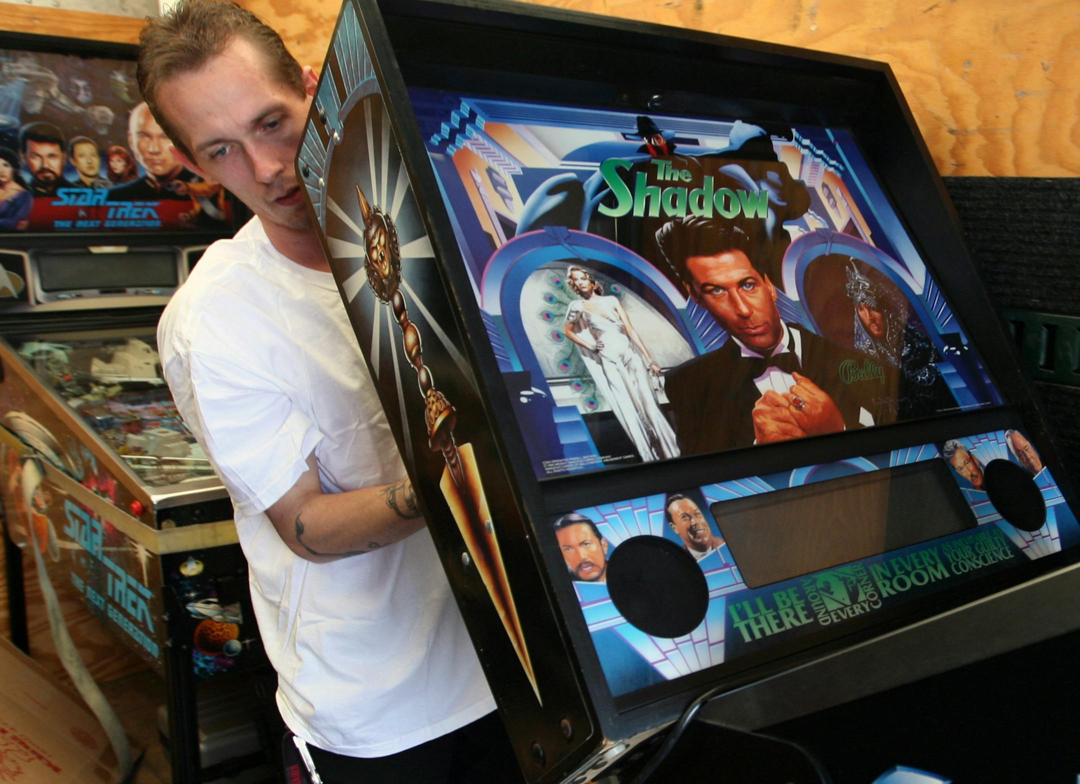 TOM WALLACE � twallace@startribune.com
Assign: 00004233AA slug: arcade0825 August21, 2008
Not just any old game will do. Eclipse Records is opening a vintage arcade. Tim Daly's company, Awe Vending, delivered some vintage, stand-up arcade games to Eclipse during the week. {Cory Blantner unloads a pinball machine to Eclipse.