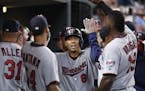 Minnesota Twins' Kurt Suzuki (8) celebrates his solo home run against the Detroit Tigers in the fourth inning during a baseball game in Detroit, Monda