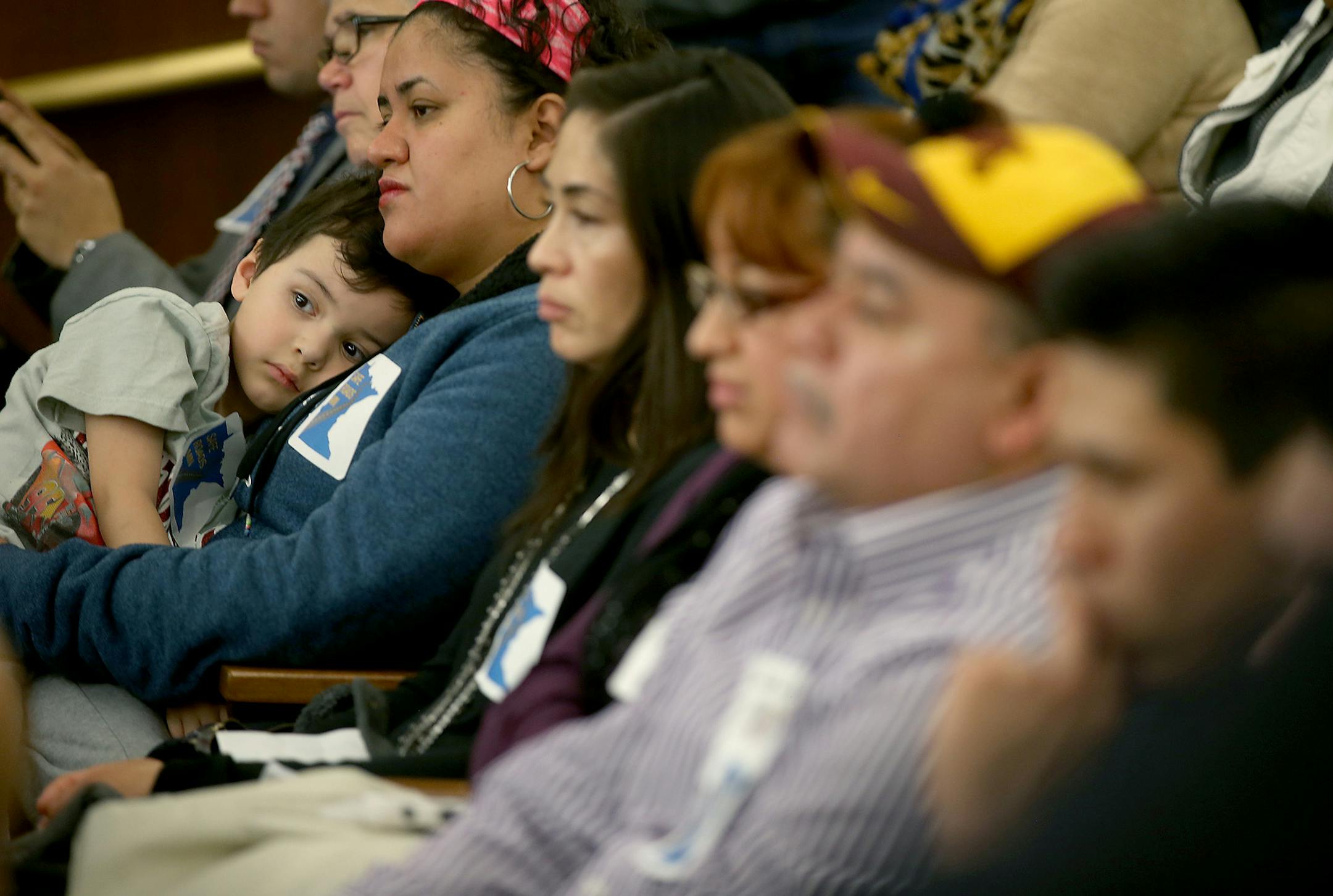 Dulce Trejo, cq, of Belle Plaine, MN., held her son Justino Garcia Trejo, 4, as she listened to supporters of a proposal to allow immigrants living in the state illegally to get driver's licenses, share their experiences to the Minnesota House transportation committee, Wednesday, March 25, 2015 in the State Office Building in St. Paul, MN. The proposal passed a Senate committee last week, and it enjoys some unprecedented Republican support in the House. But amid concerns about voter fraud and ot