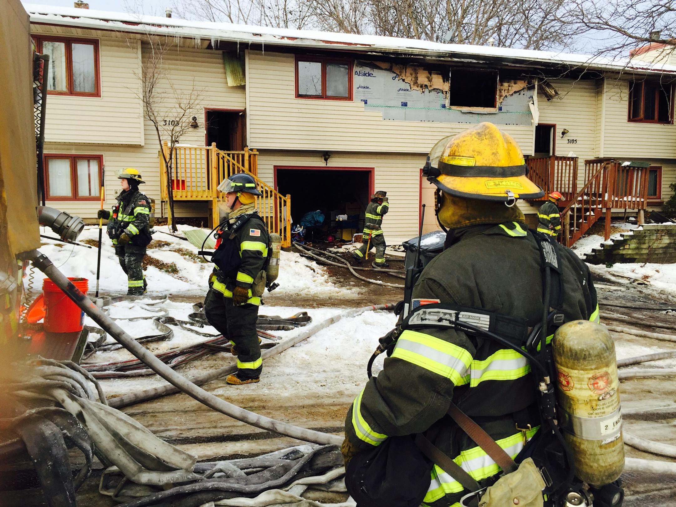 Firefighters work the scene of a duplex fire in North Minneapolis on Jan. 1, 2015.
