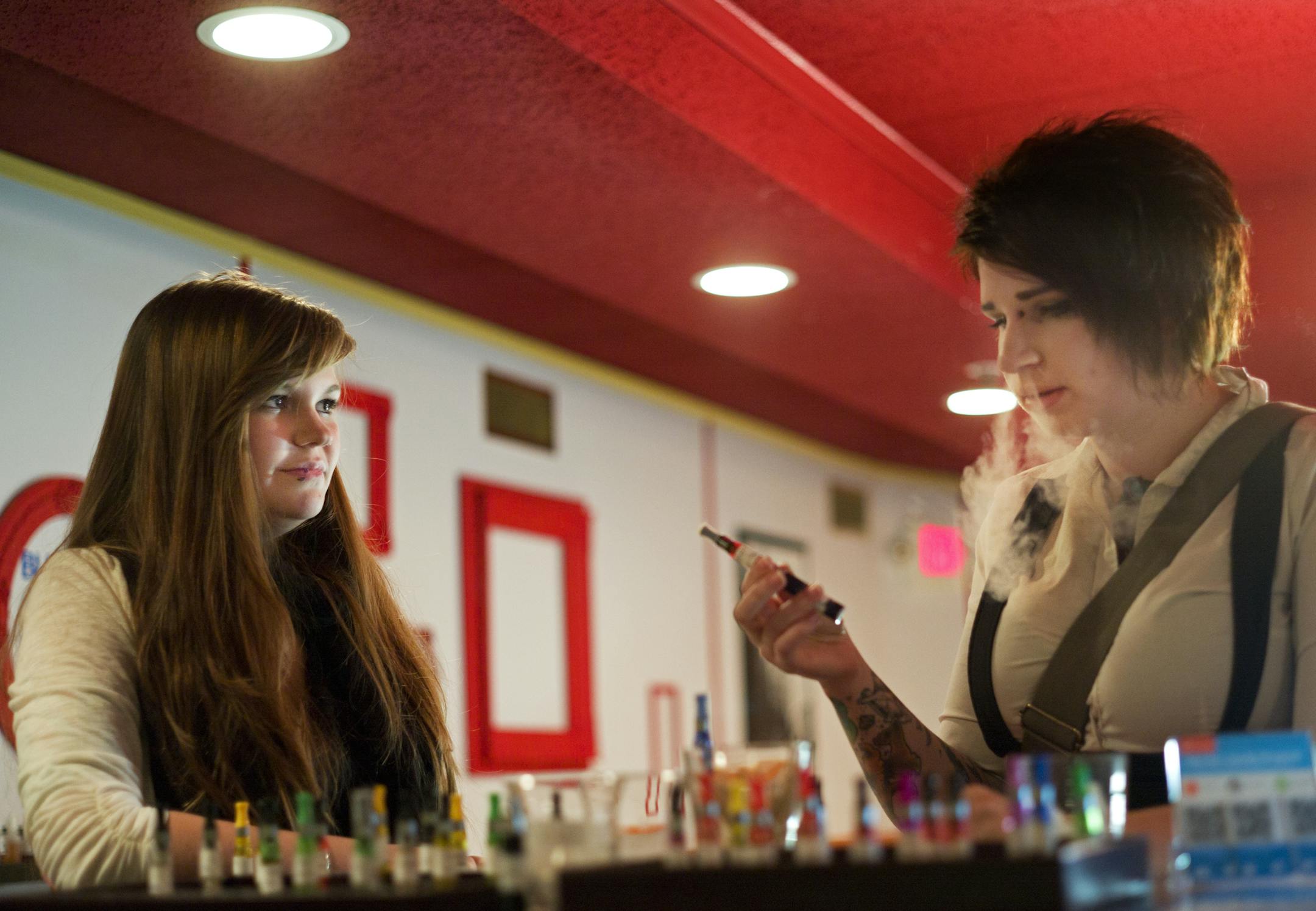 In an effort to limit a surge of e-cigarette/ vaping lounges, Hopkins passed a moratorium on them after Paula Williams opened on Main Street. Manager Molly McIntosh let Haley Cybyske try out some flavors during an interview. She was hired to start next week. ]richard tsong-taatarii/rtsongtaataarii@startribune.com