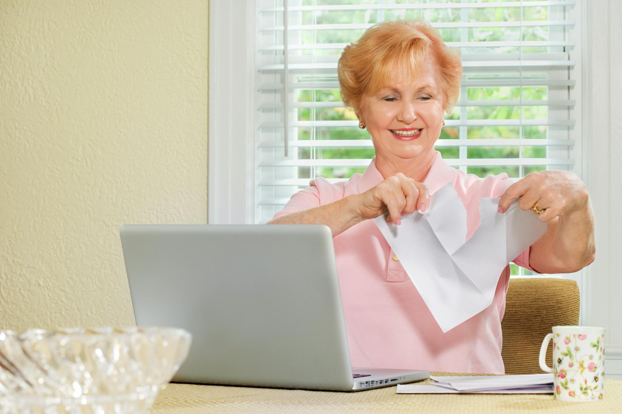 senior woman working with laptop and finances