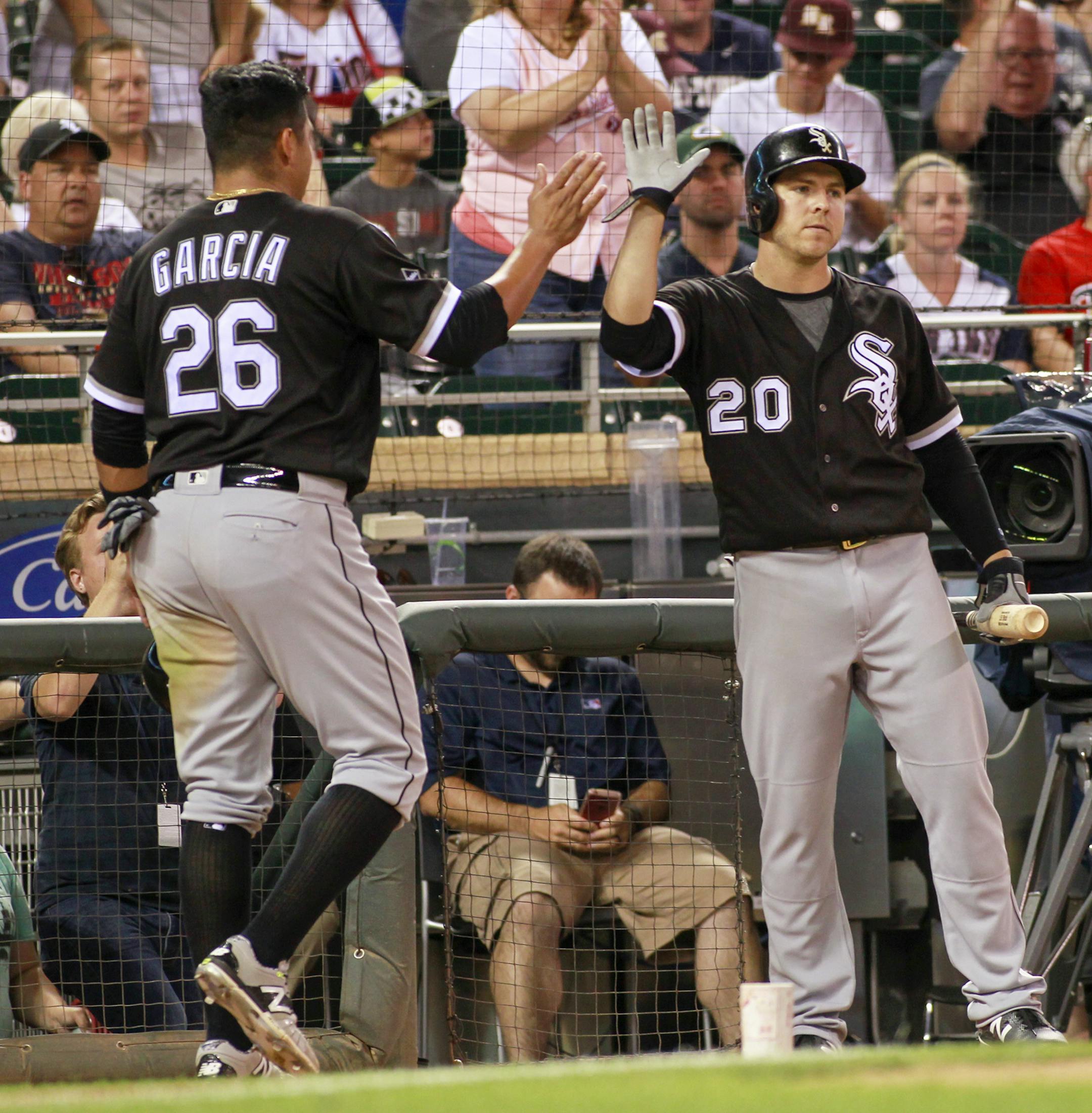Chicago White Sox's Avisail Garcia (26) is congratulated by teammate J.B. Shuck (20) after scoring the winning run during the 10th inning of an baseball game against the Minnesota Twins, Saturday, July 30, 2016, in Minneapolis. (AP Photo/Paul Battaglia)