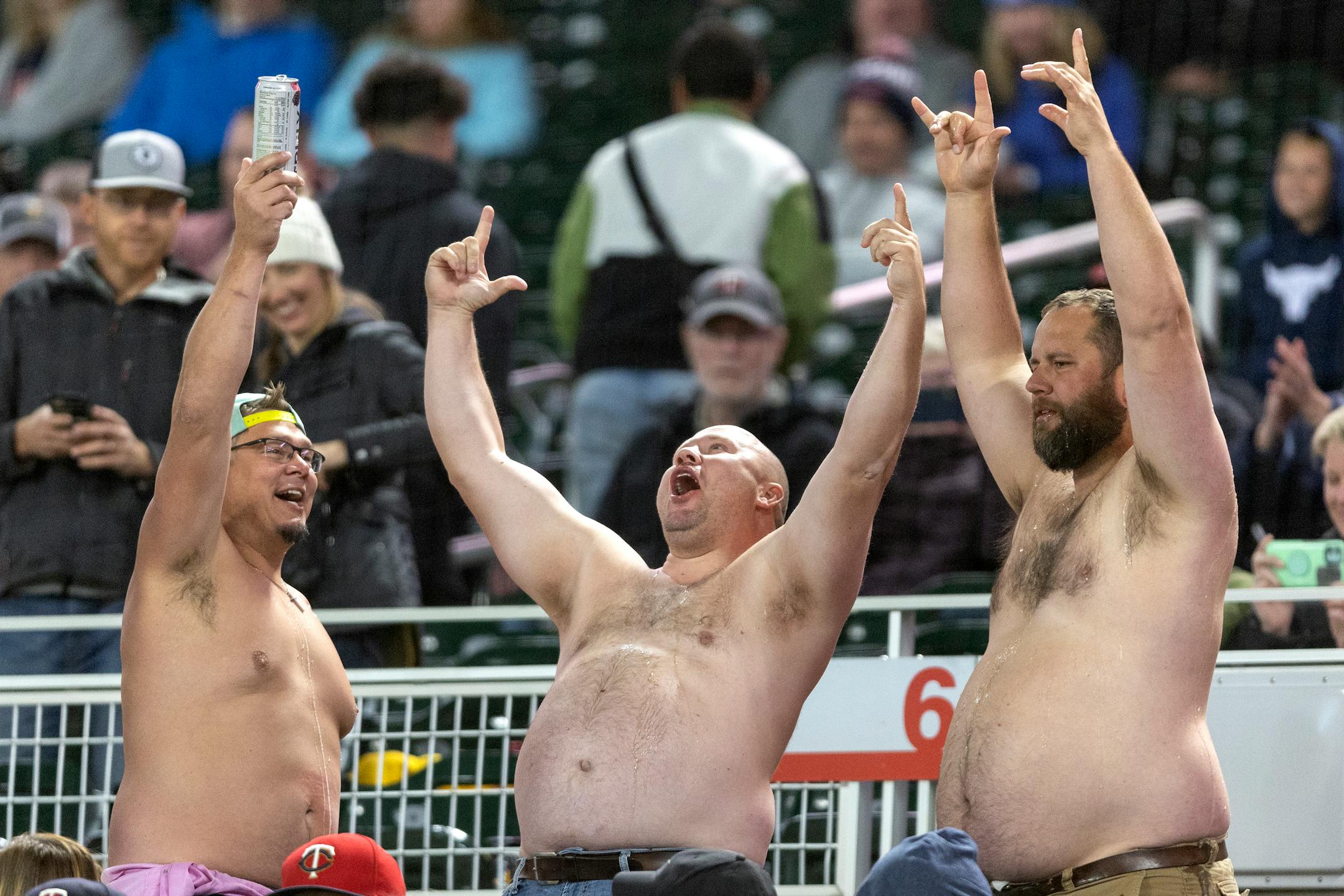 Shirtless fans drank beers in the seventh inning.